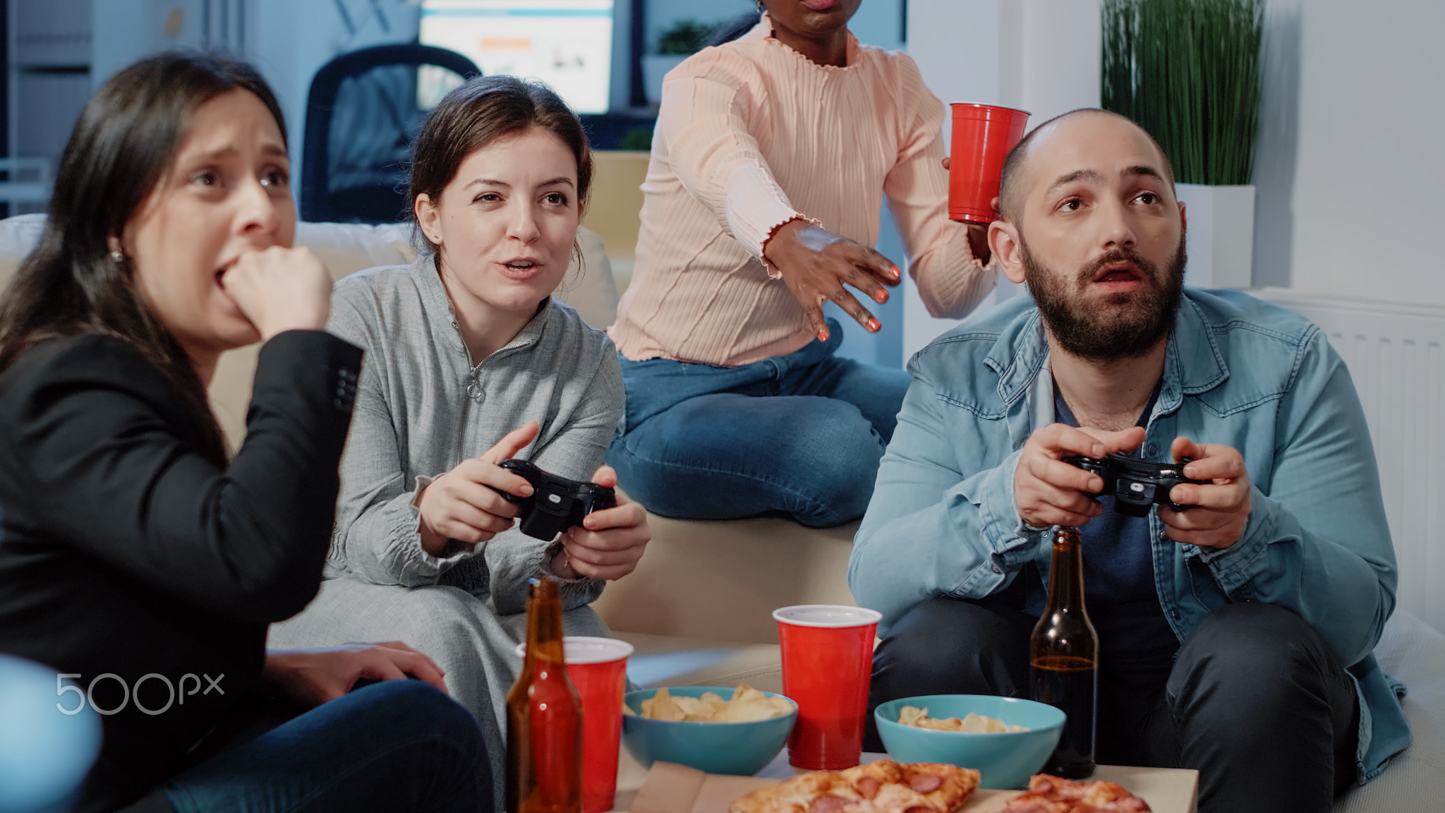 Close up of colleagues playing video games on console