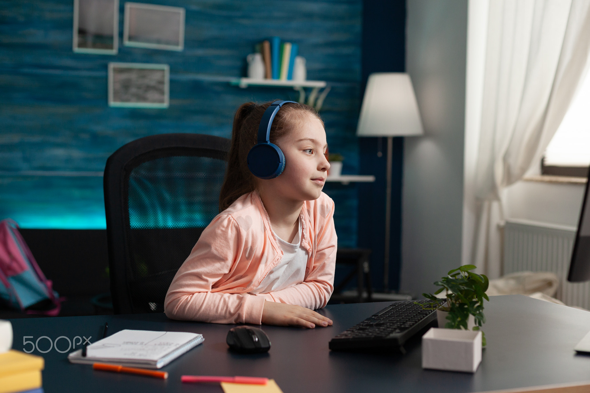 Caucasian student wearing headphones on online class