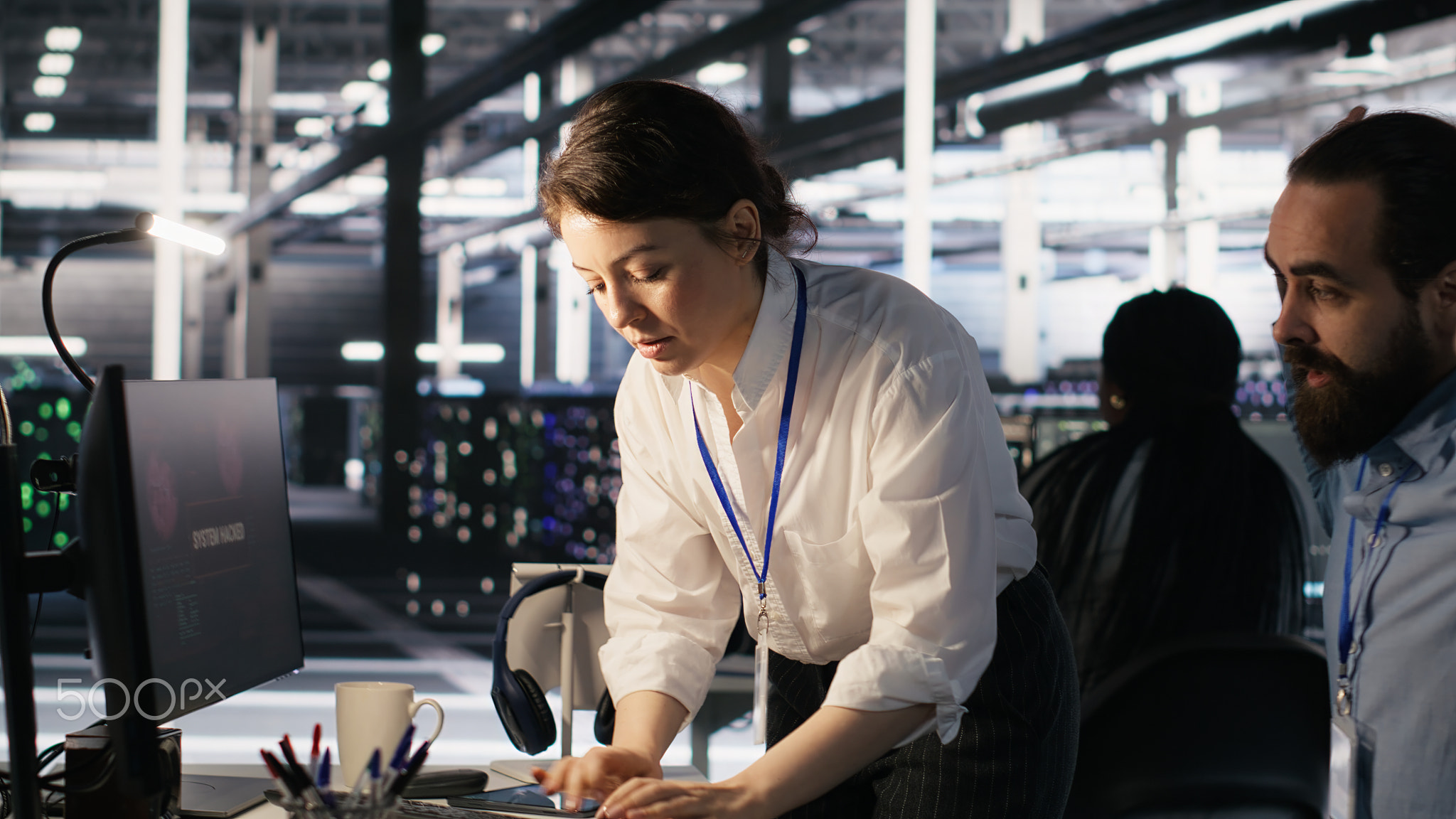 Panicked engineers in data center reacting to ransomware warning on PC