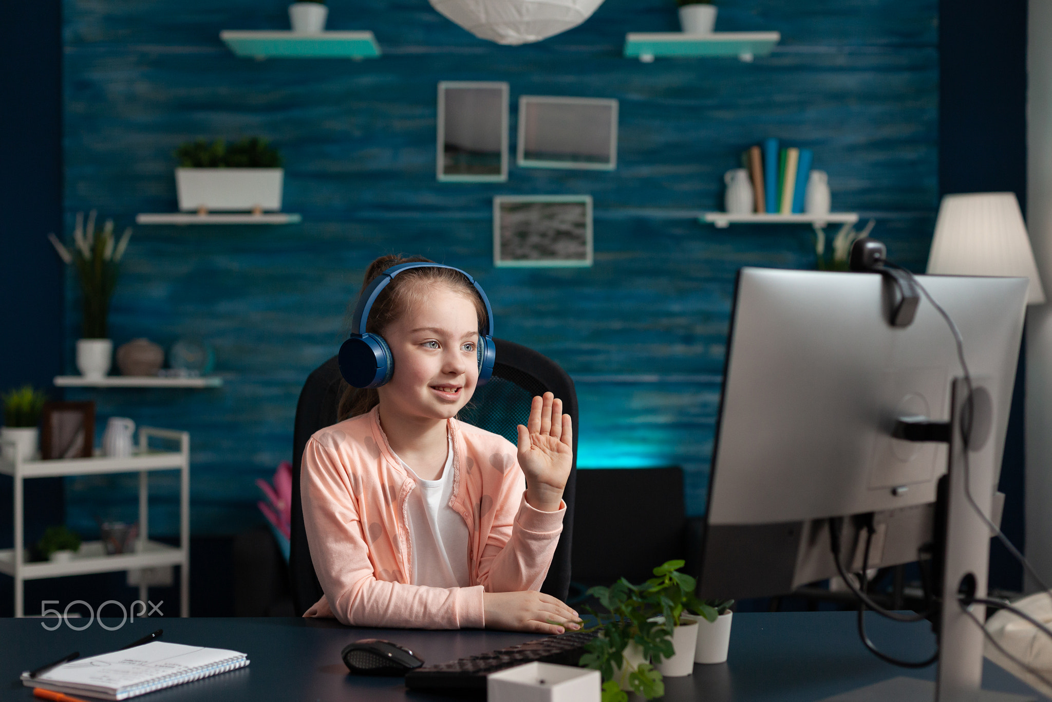 Little student waving at video call conference