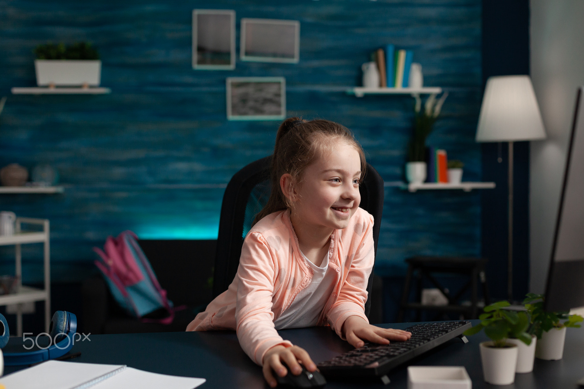 Primary schoolgirl looking at computer monitor