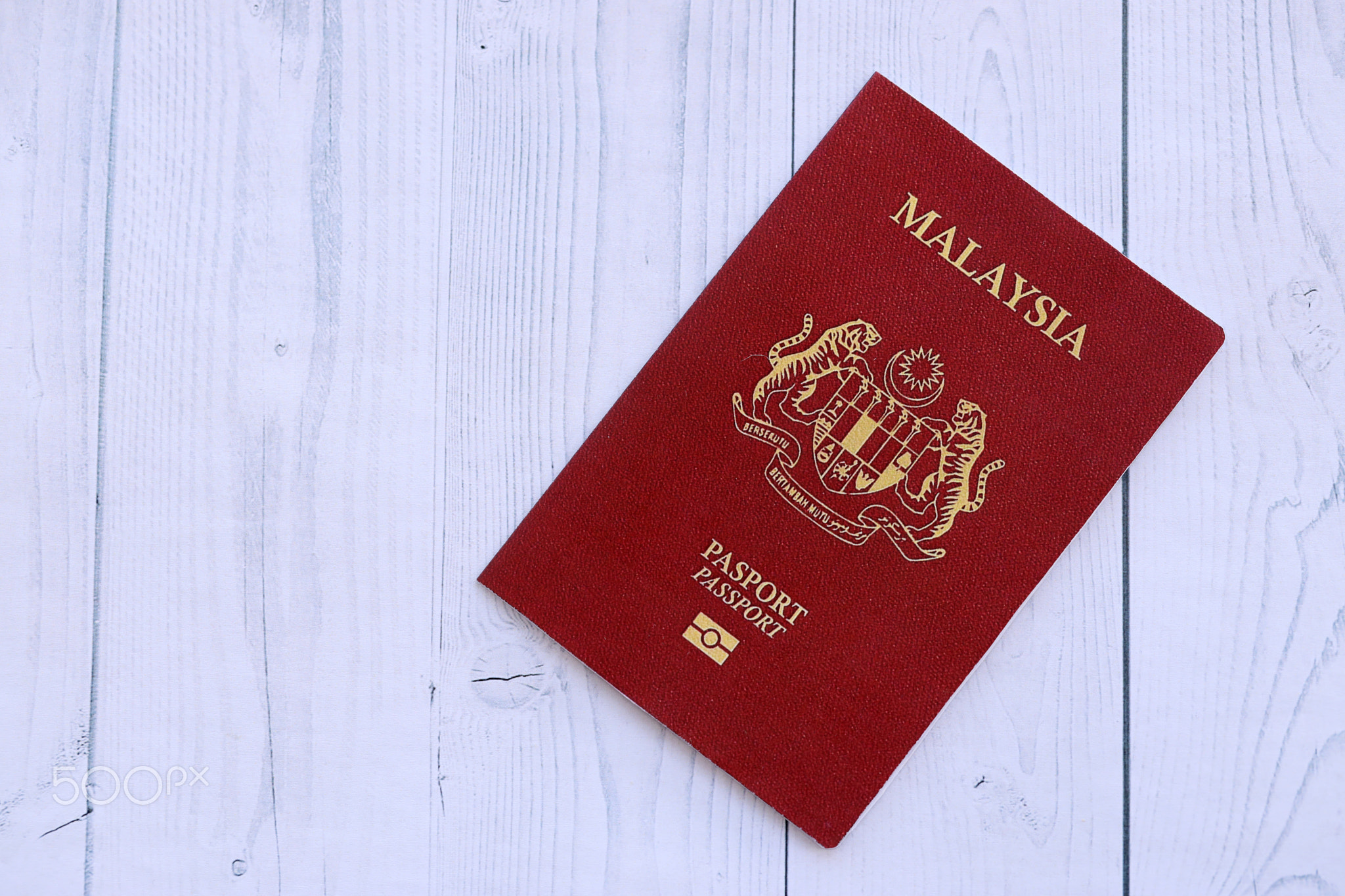 Malaysian passport on table. Official identification document book for citizens of Malaysia