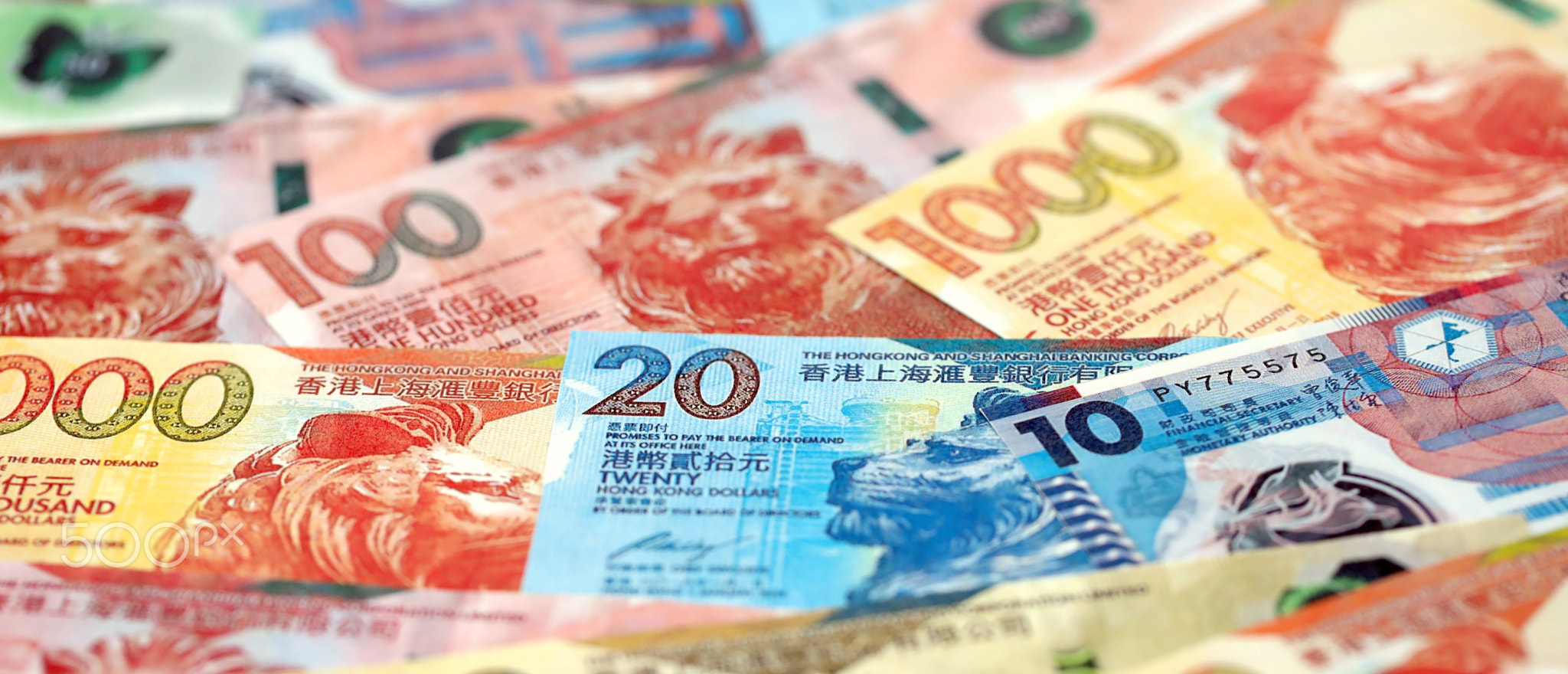 Big pile of Hong Kong dollars money bills banknotes. Lots of money of Chinese Hong Kong HKD cash