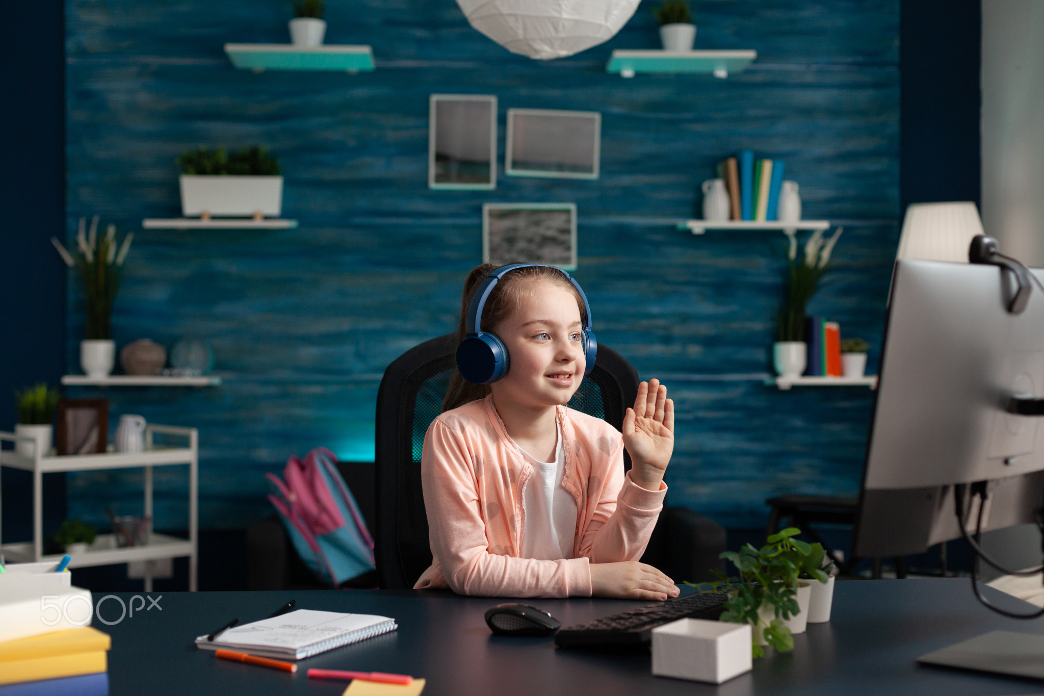 Little student waving at video call conference