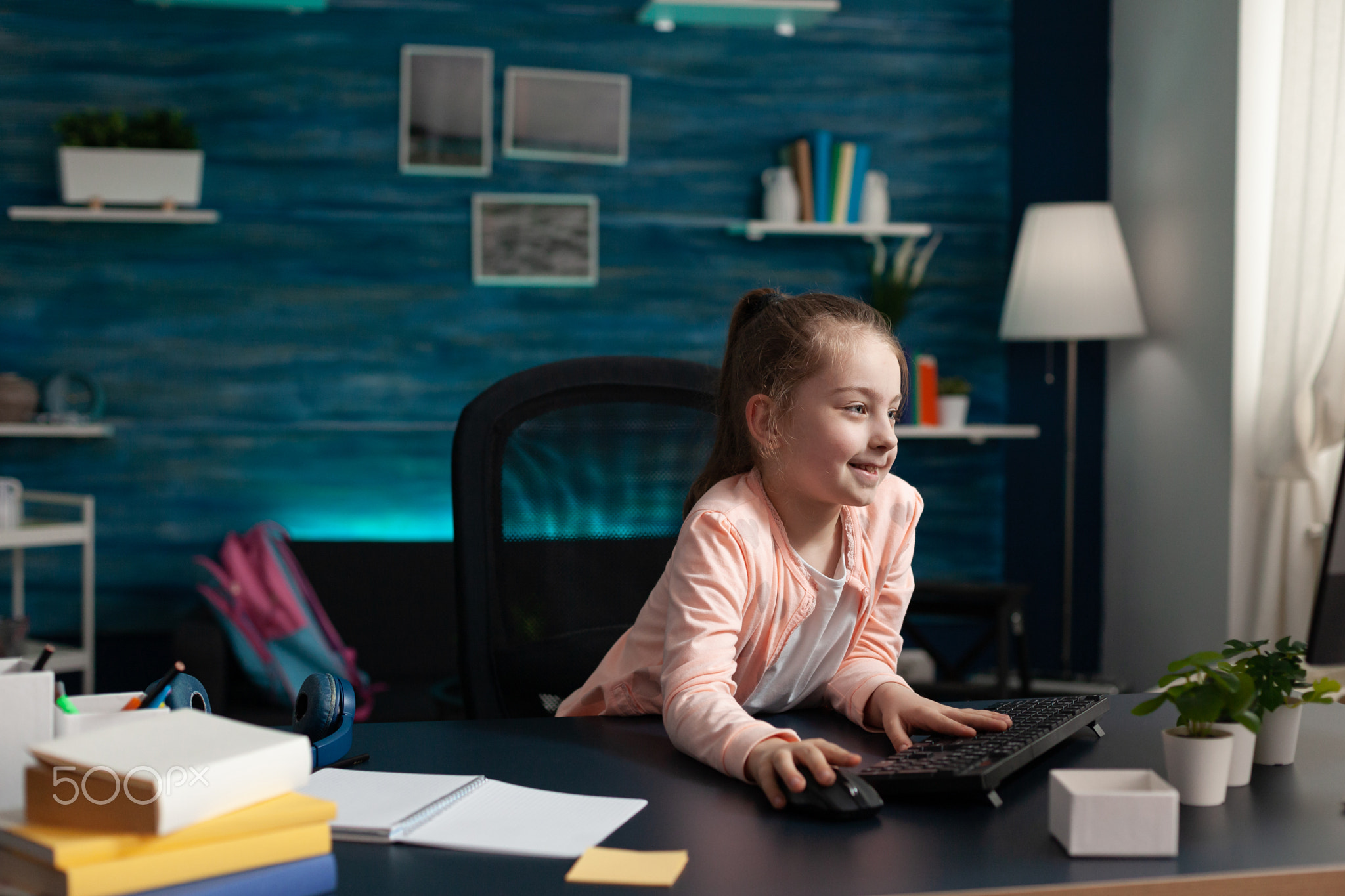 Smart little pupil looking at computer monitor screen
