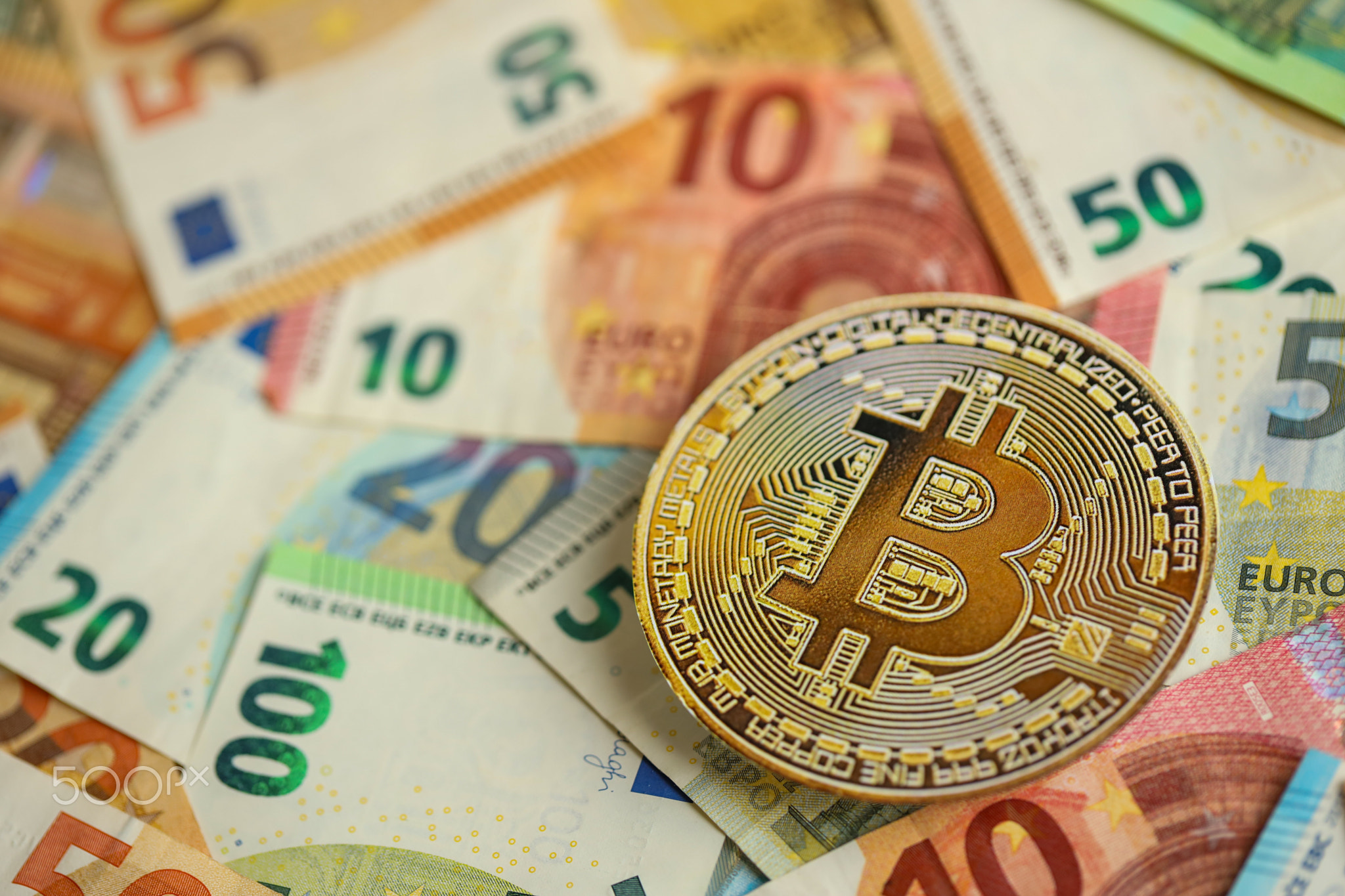 Bitcoin BTC coin with big amount of european euro bills