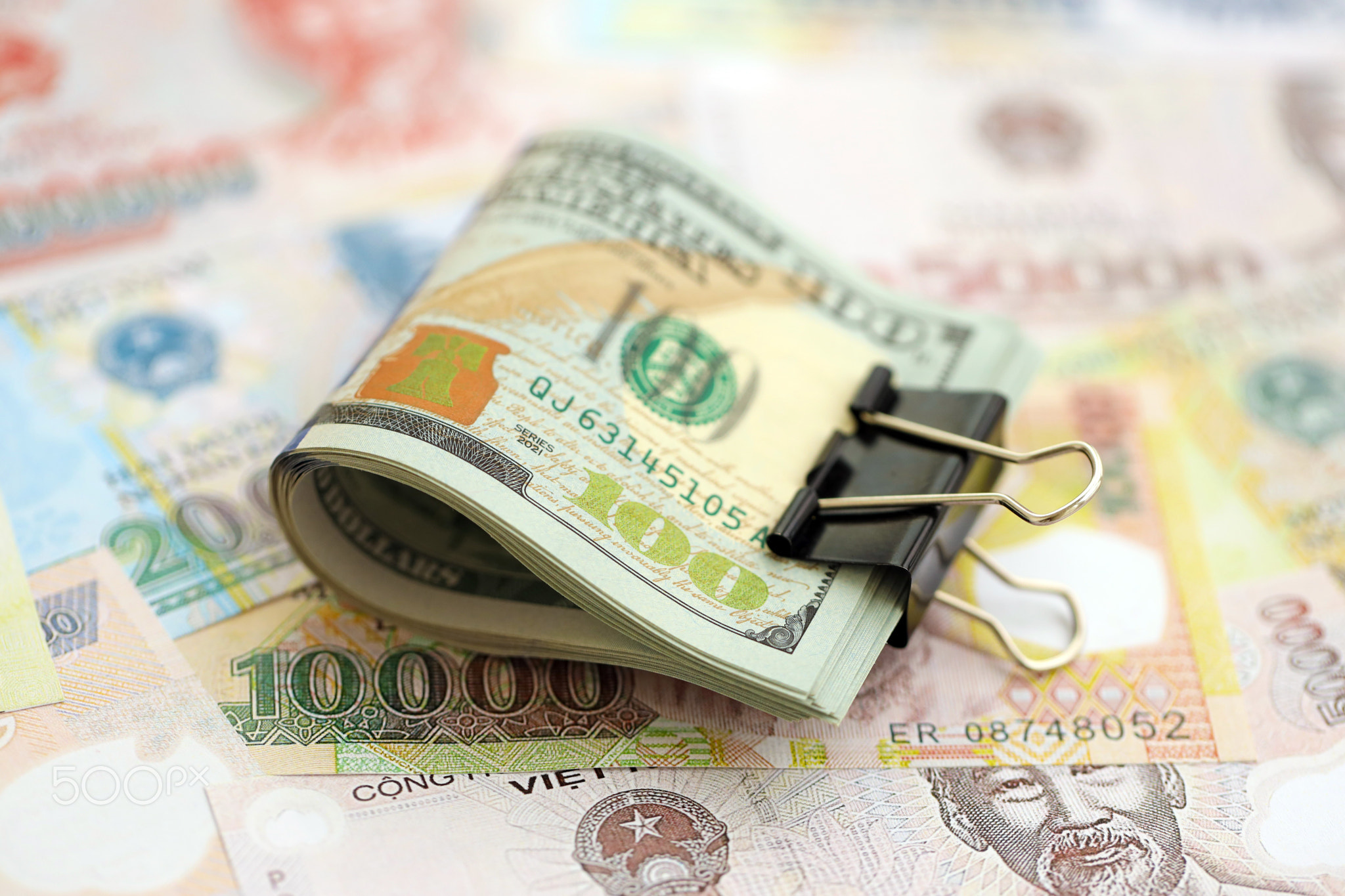 Vietnamese dong currency money bills and bunch of us dollar banknotes. The concept of economics and