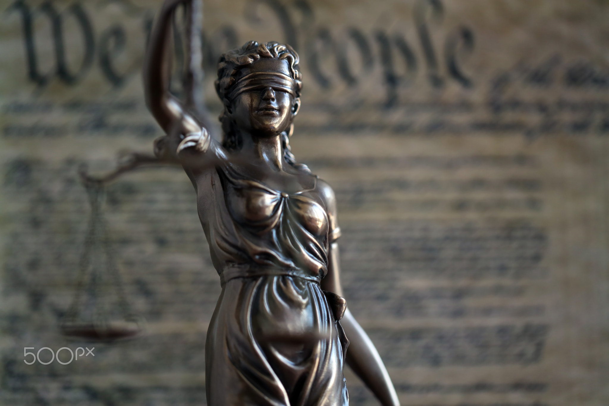 Dark scene with Lady Justice and US Constitution page. Lawsuit and judgement in USA