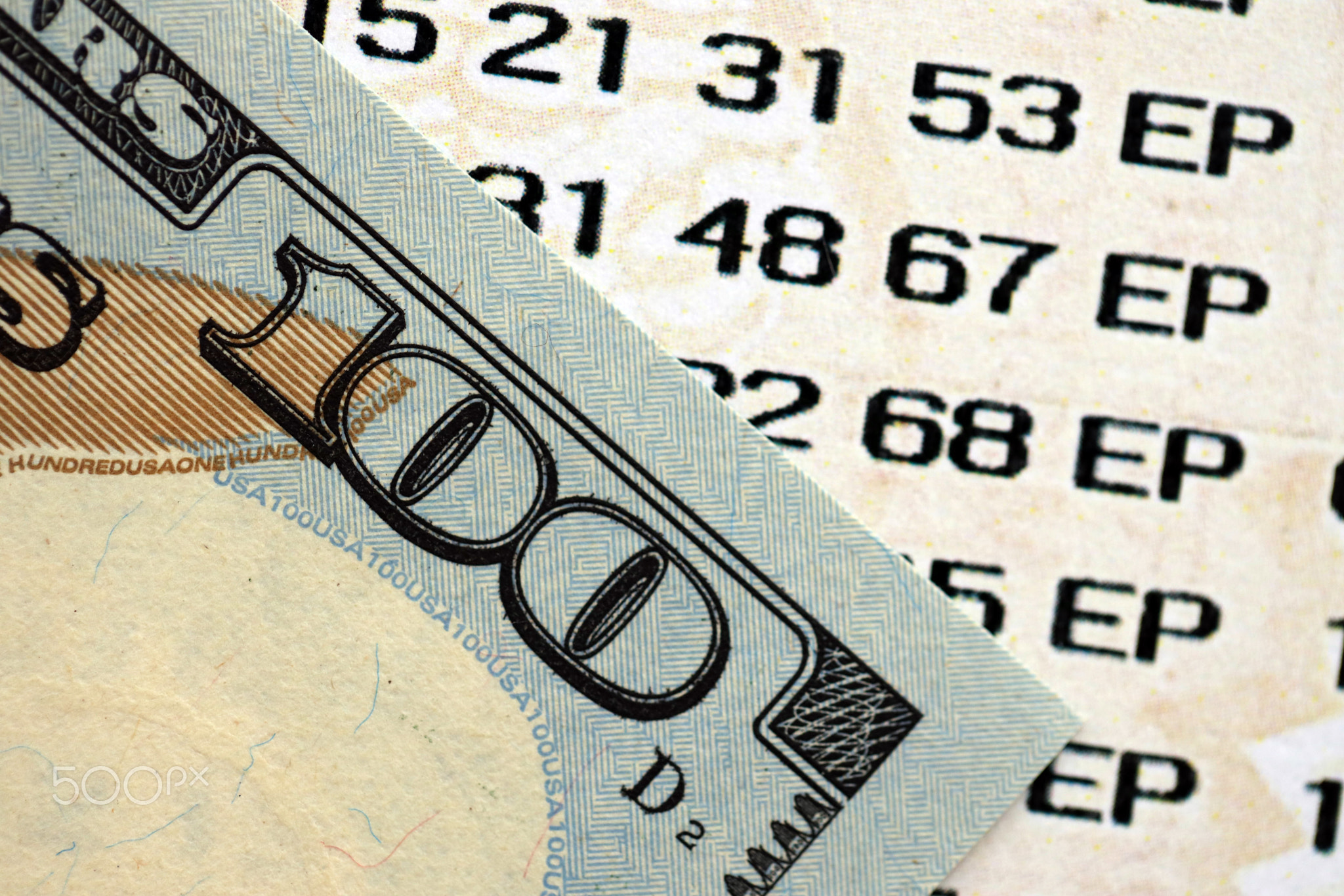 Lottery ticket and one hundred US dollar bill close up. Concept of gambling addiction