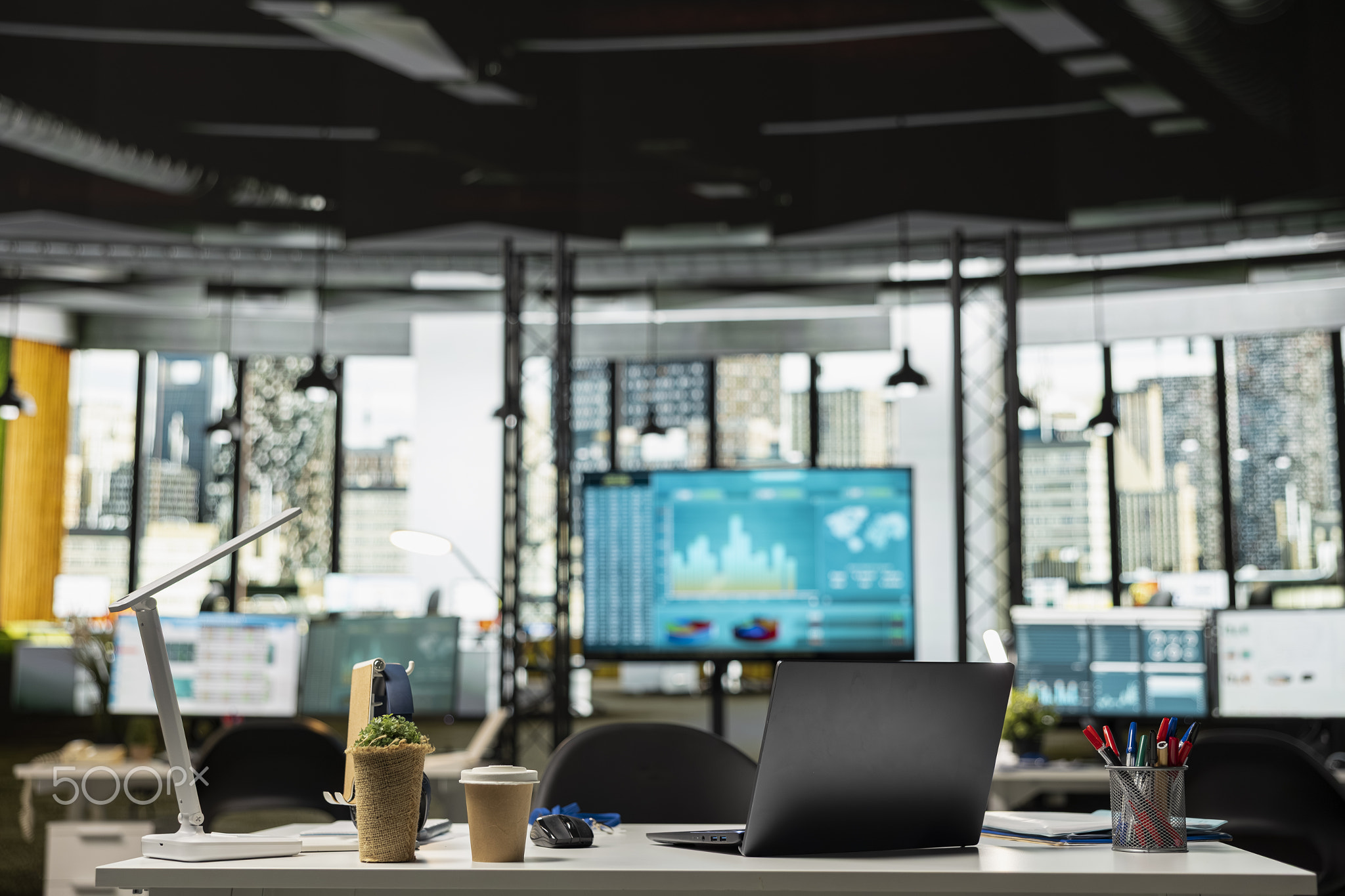 Empty office workspace with laptop on desk