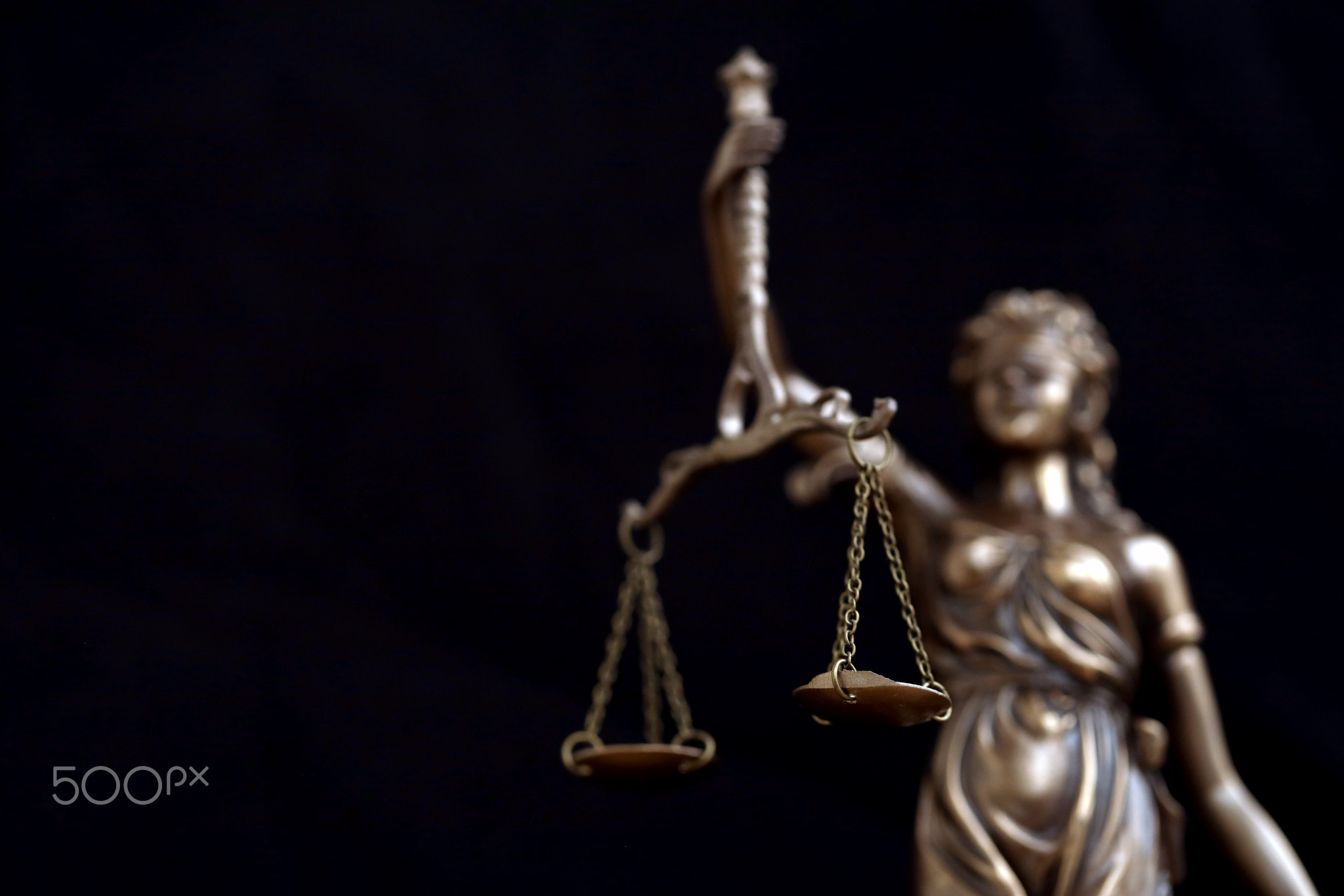 Lady Justice statue in law on black backdrop. Law and justice