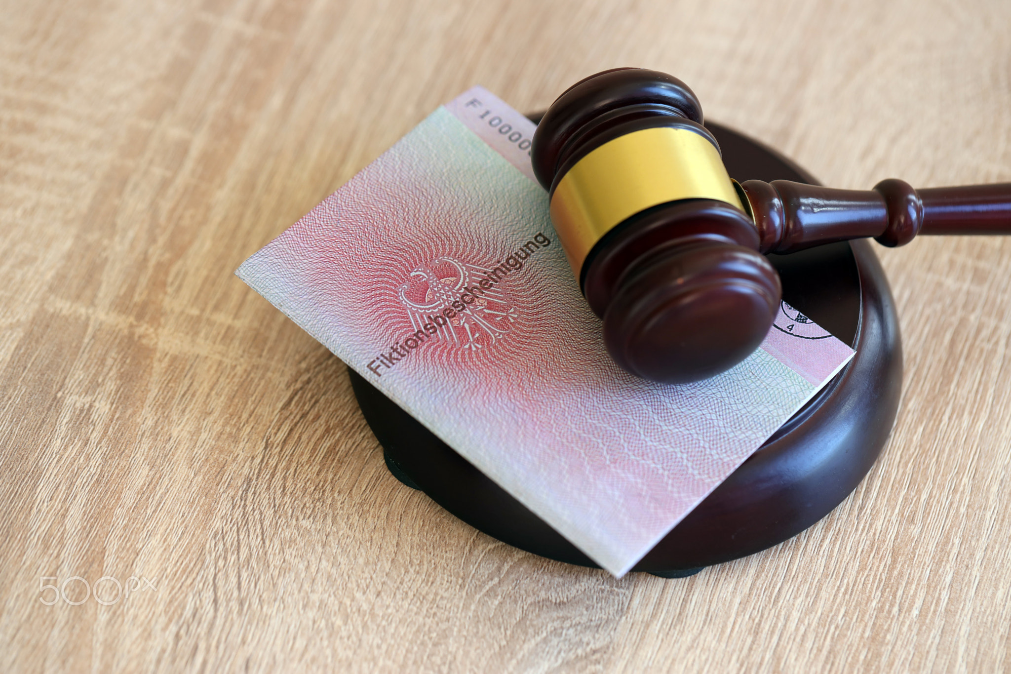 German temporary Permanent resident card specimen lies with judge hammer. Fiktionsbescheinigung