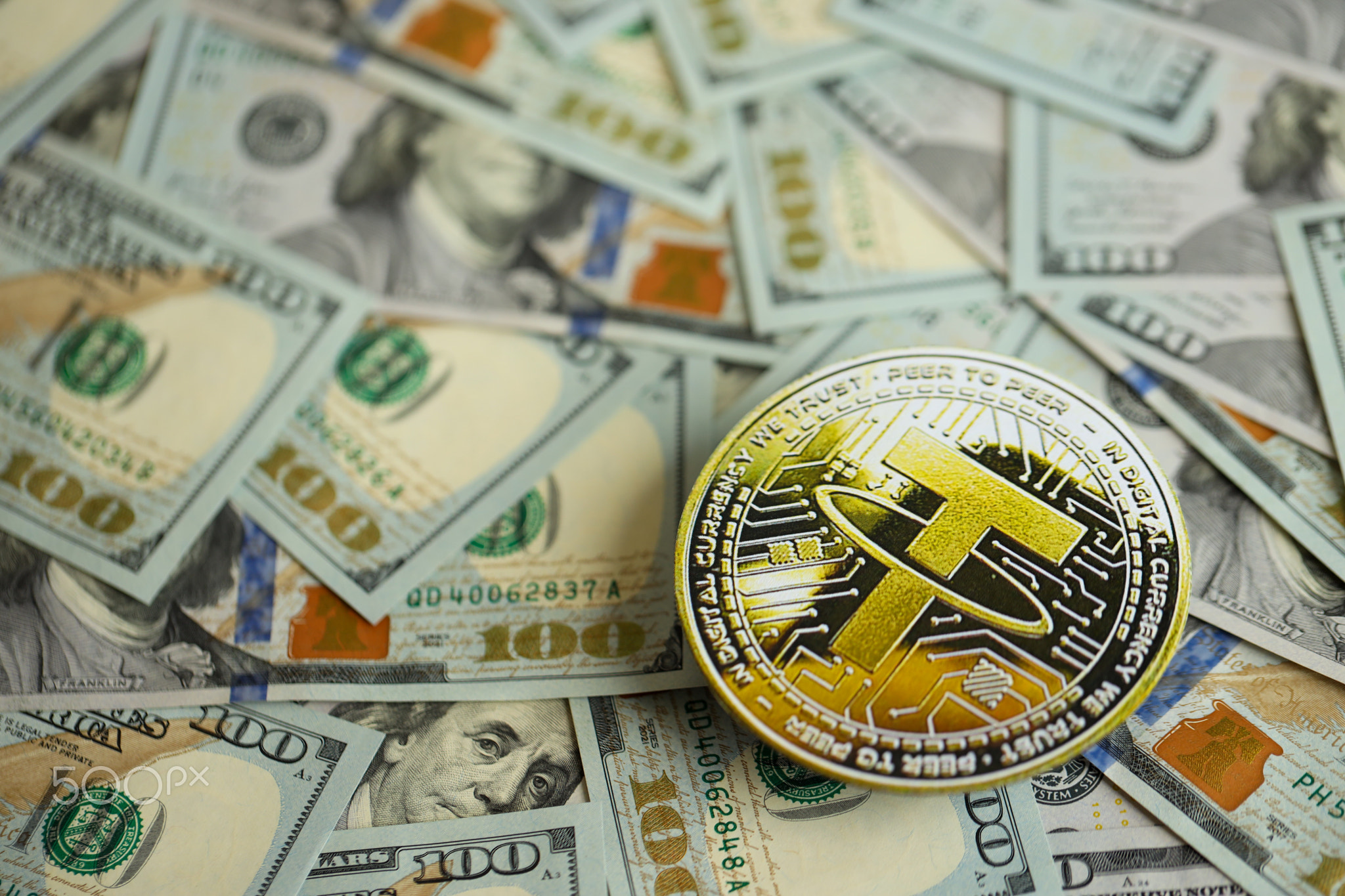 Tether USDT coin on big amount of hundred US dollar bills