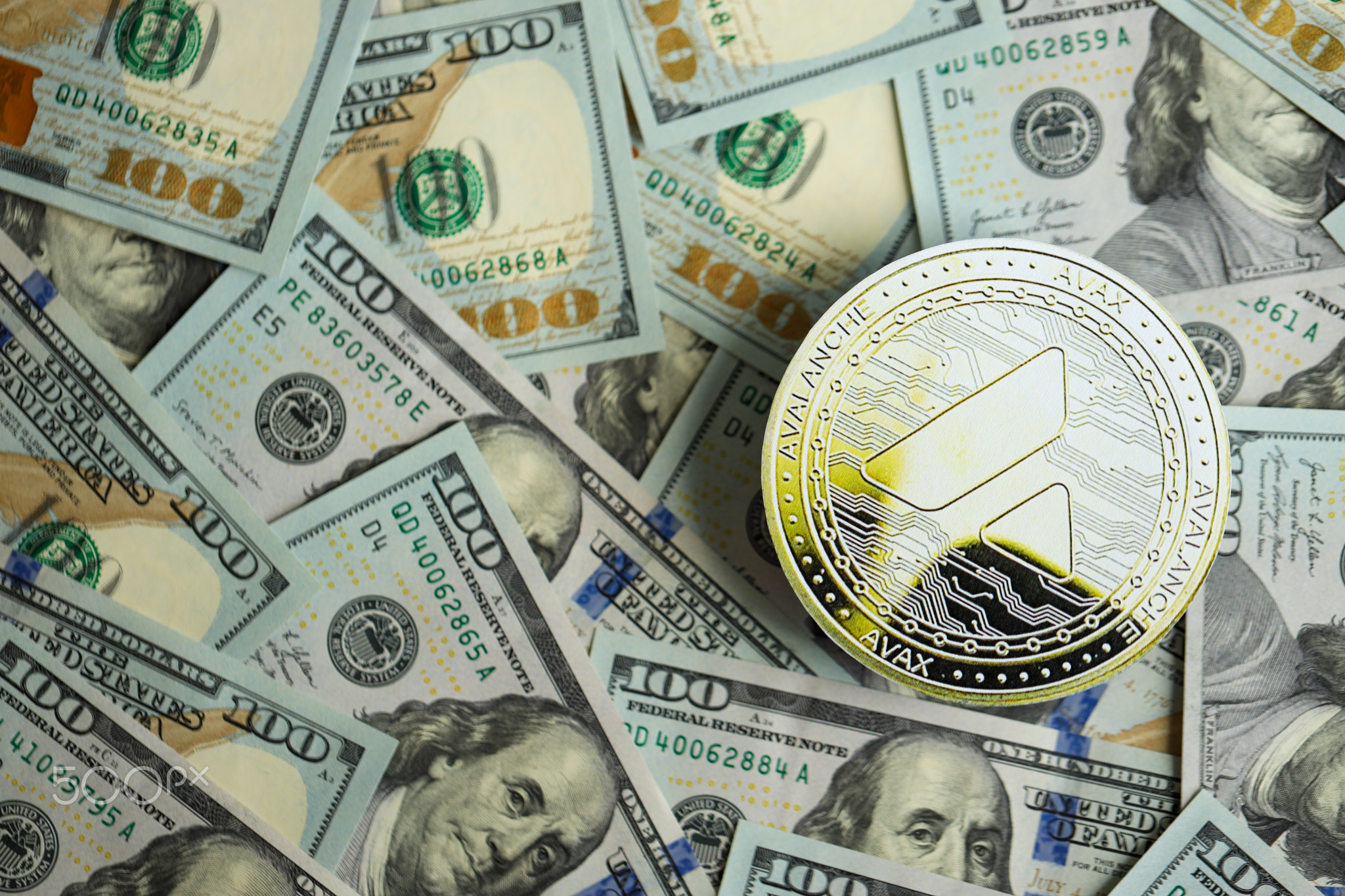 Avalanche AVAX coin on big amount of hundred US dollar bills