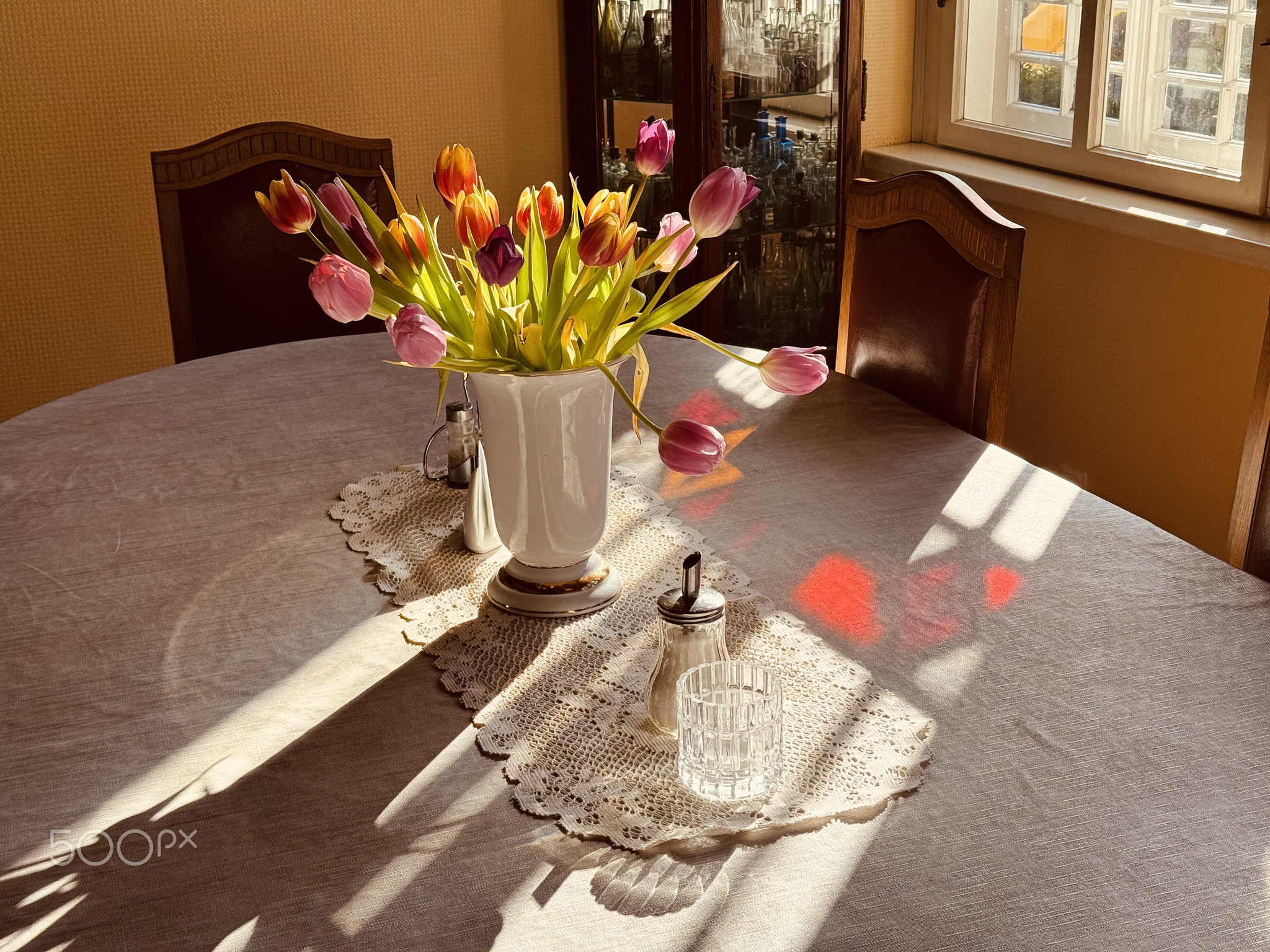 Interior of an old house in Eastern Europe. A vase of flowers on a table.