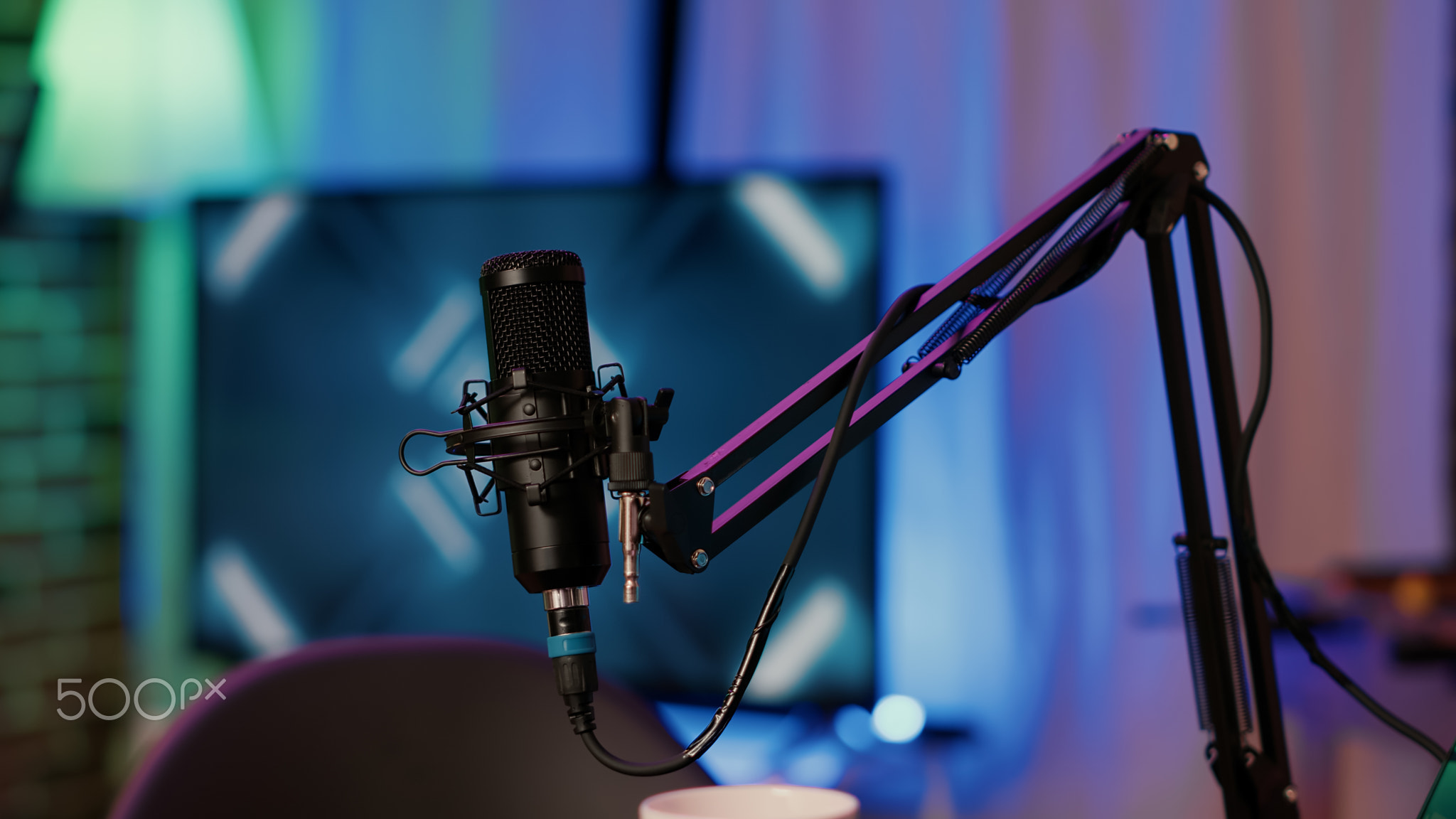 Selective focus on professional boom arm microphone stand used for recording voice in online podcast