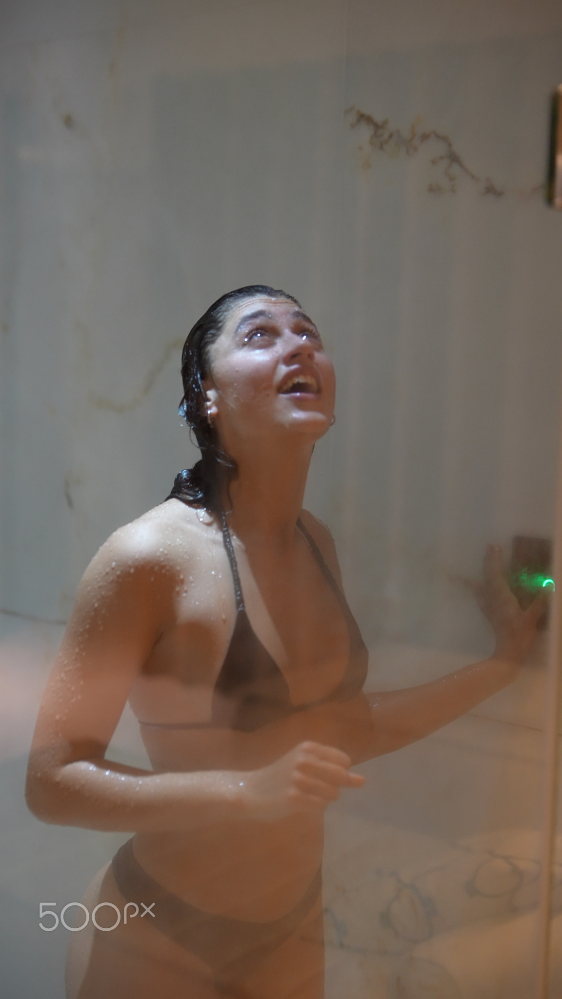 Individual finetunes bathroom settings seamlessly during soothing shower