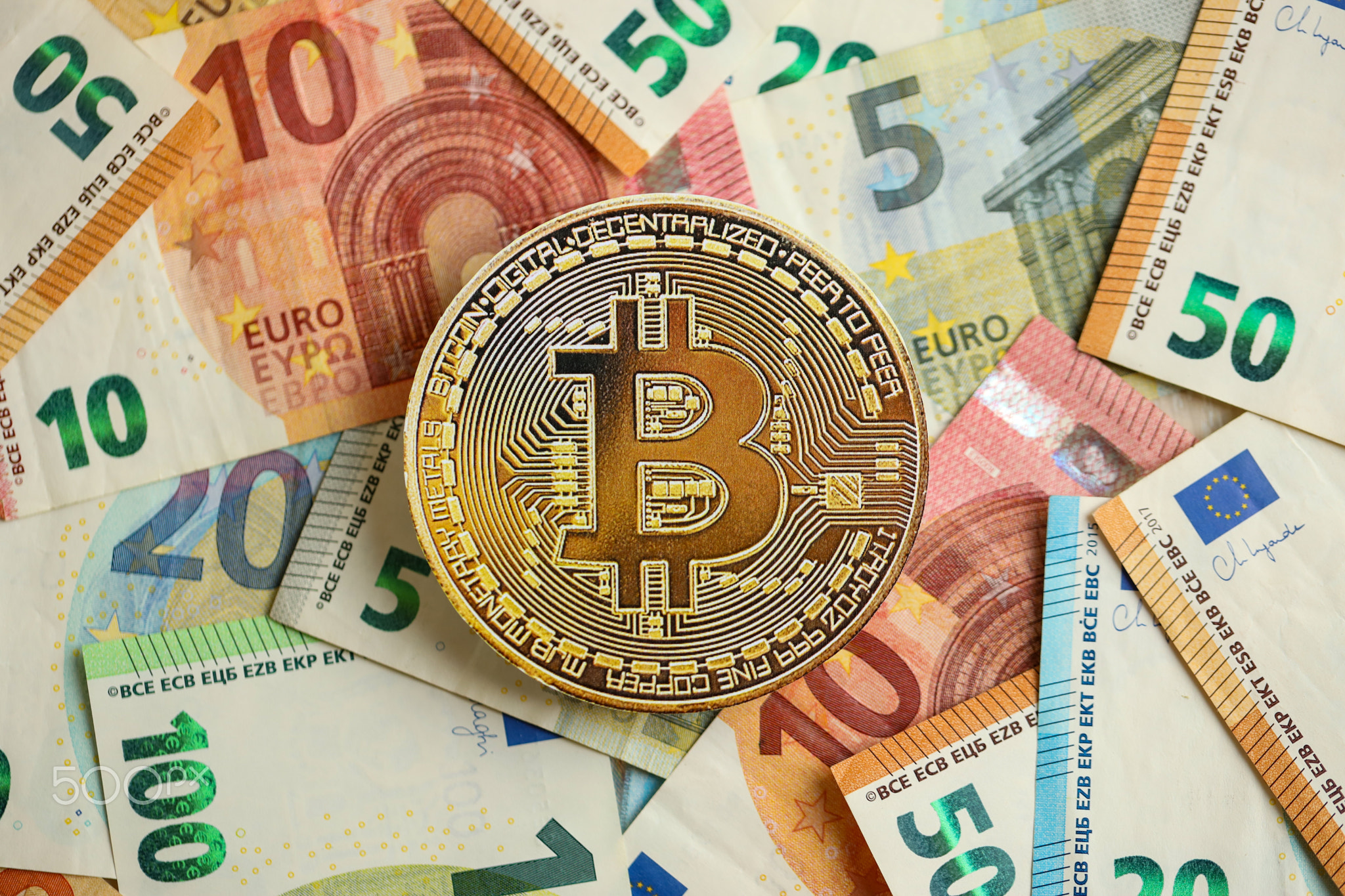 Bitcoin BTC coin with big amount of european euro bills