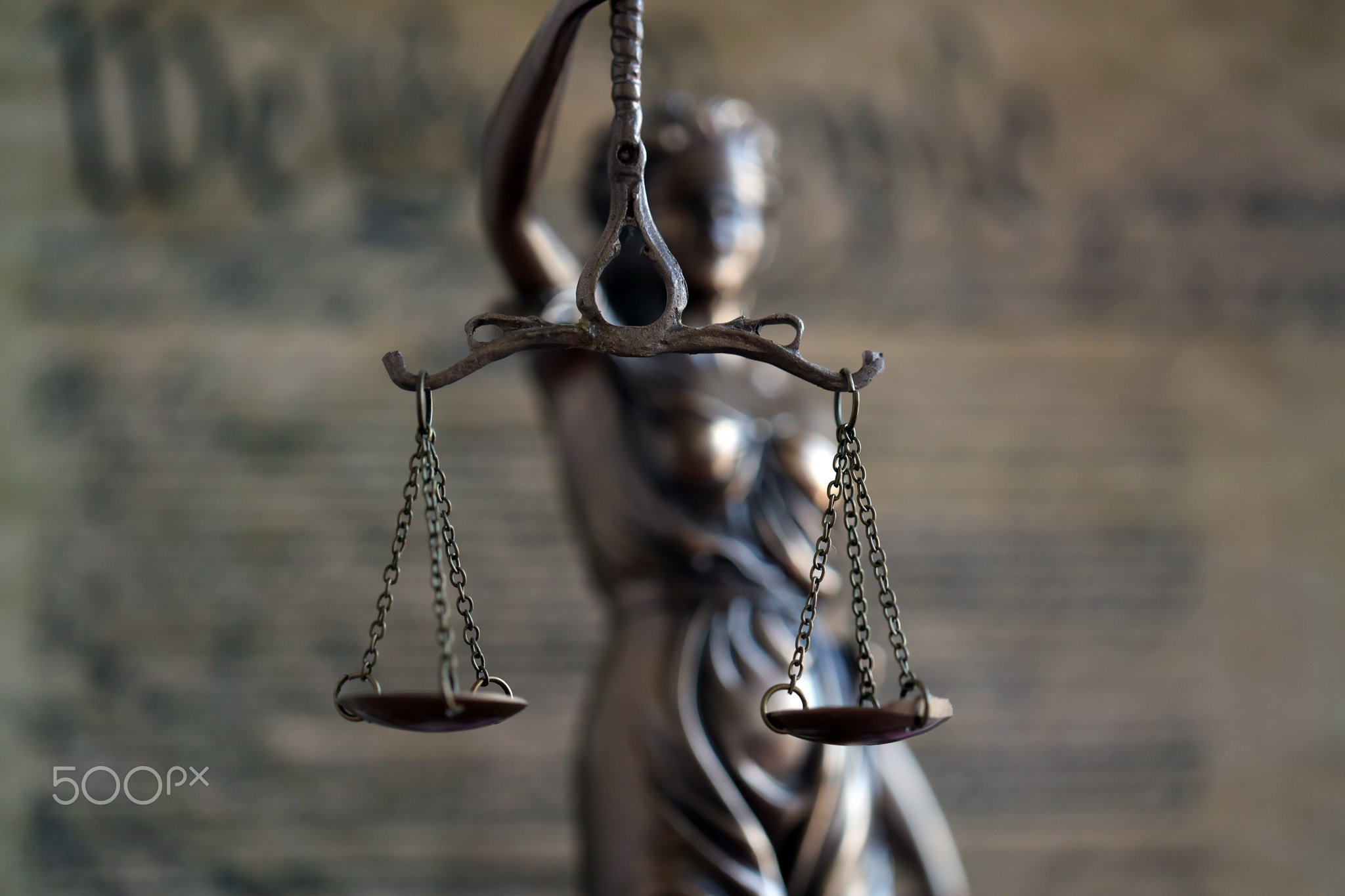 Lady Justice and background of US Constitution page. Lawsuit and judgement in US