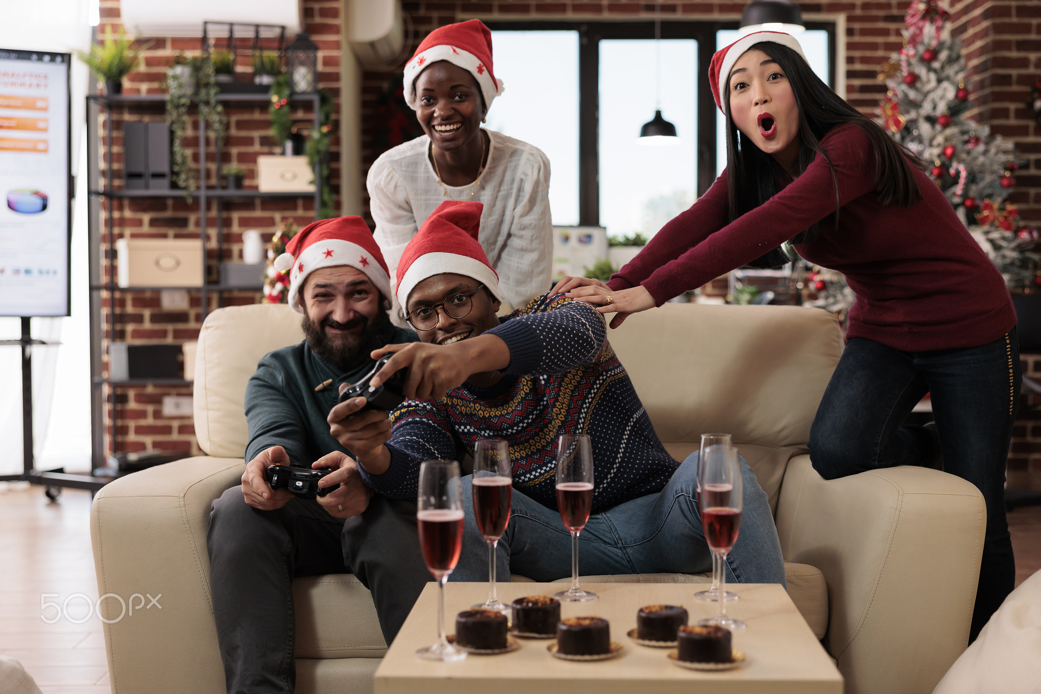 Festive work colleagues playing online video games