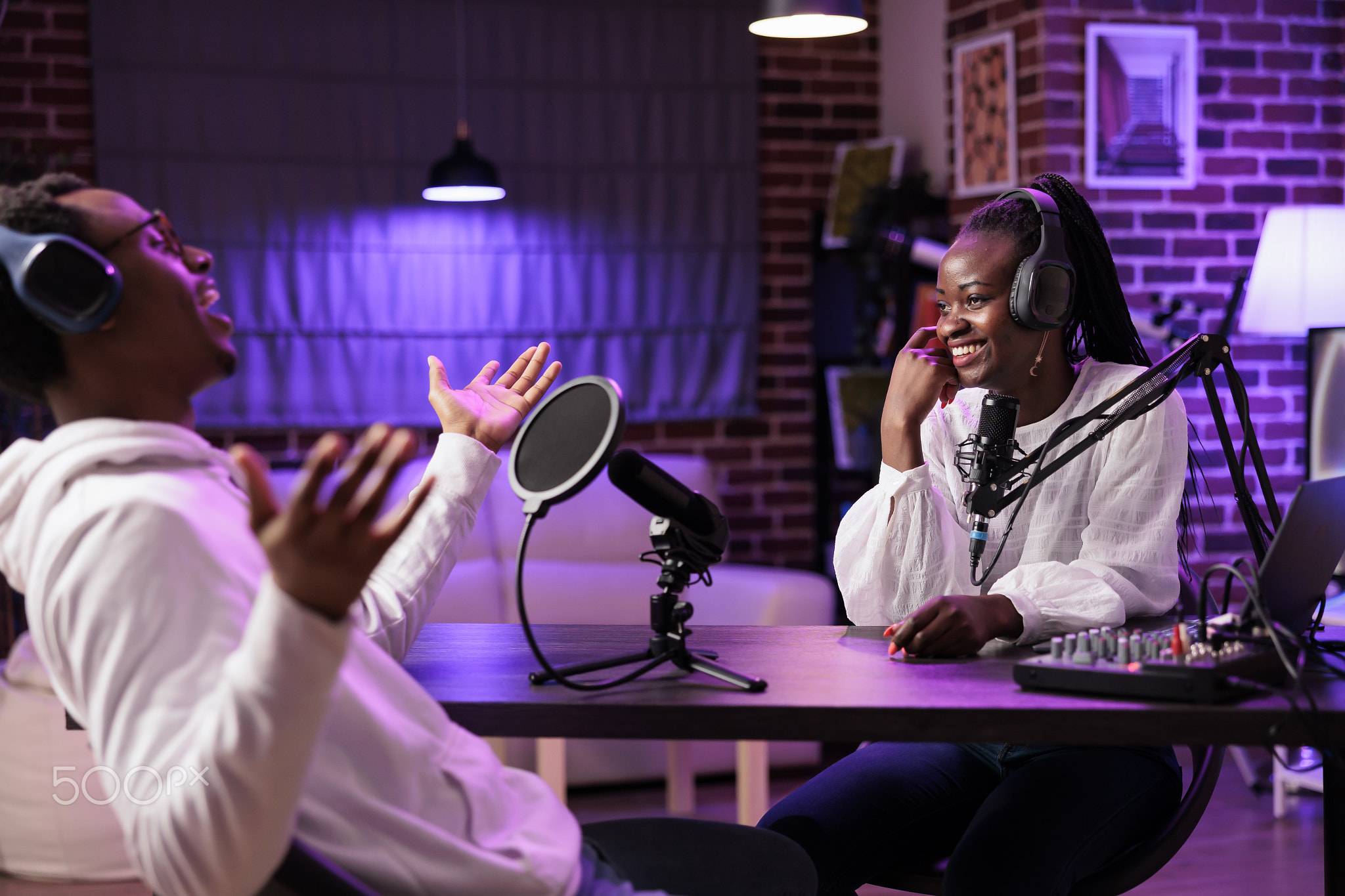 Podcast host laughing with guest