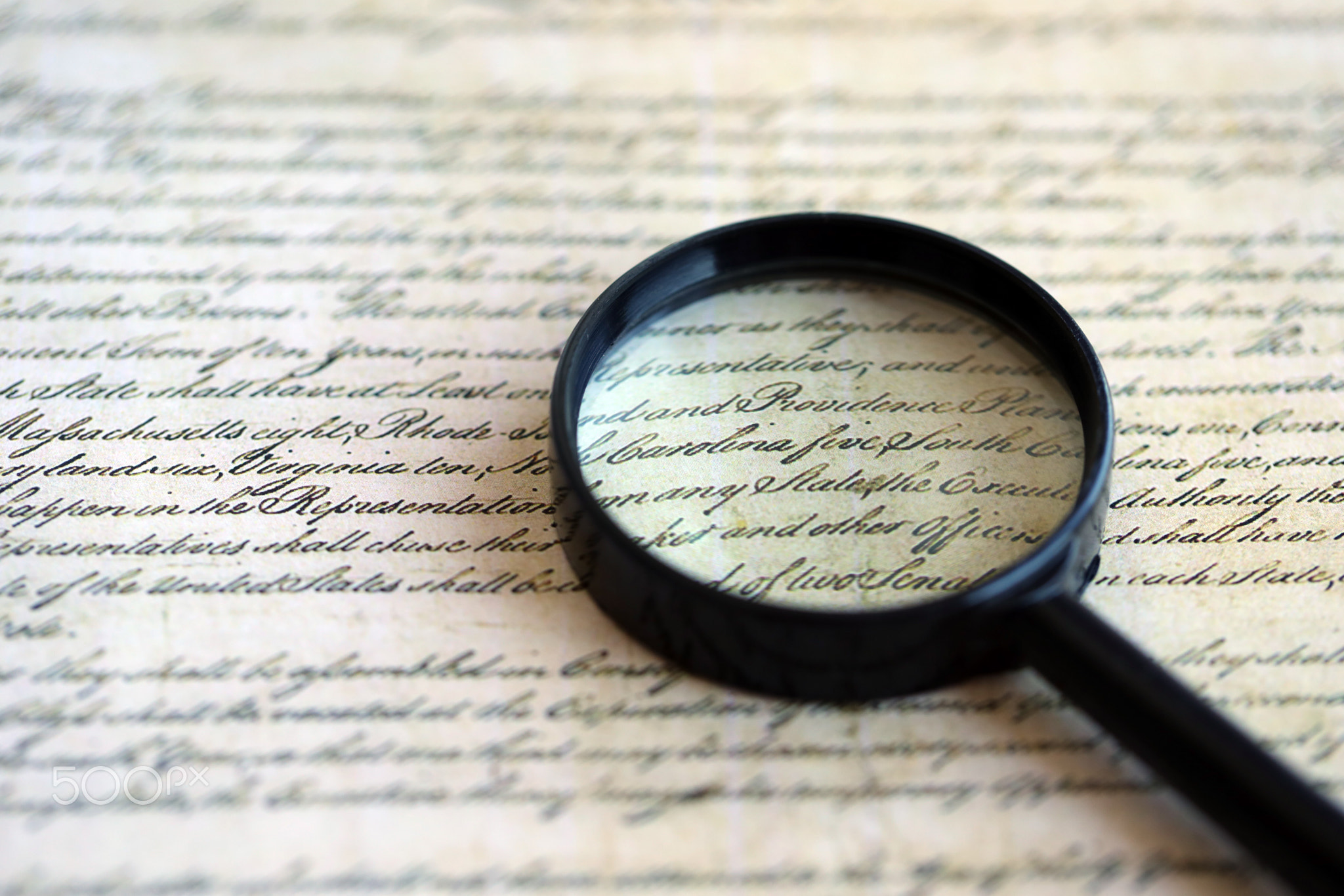 Magnifying glass and United States Constitution. American USA Constitution paper page and loupe