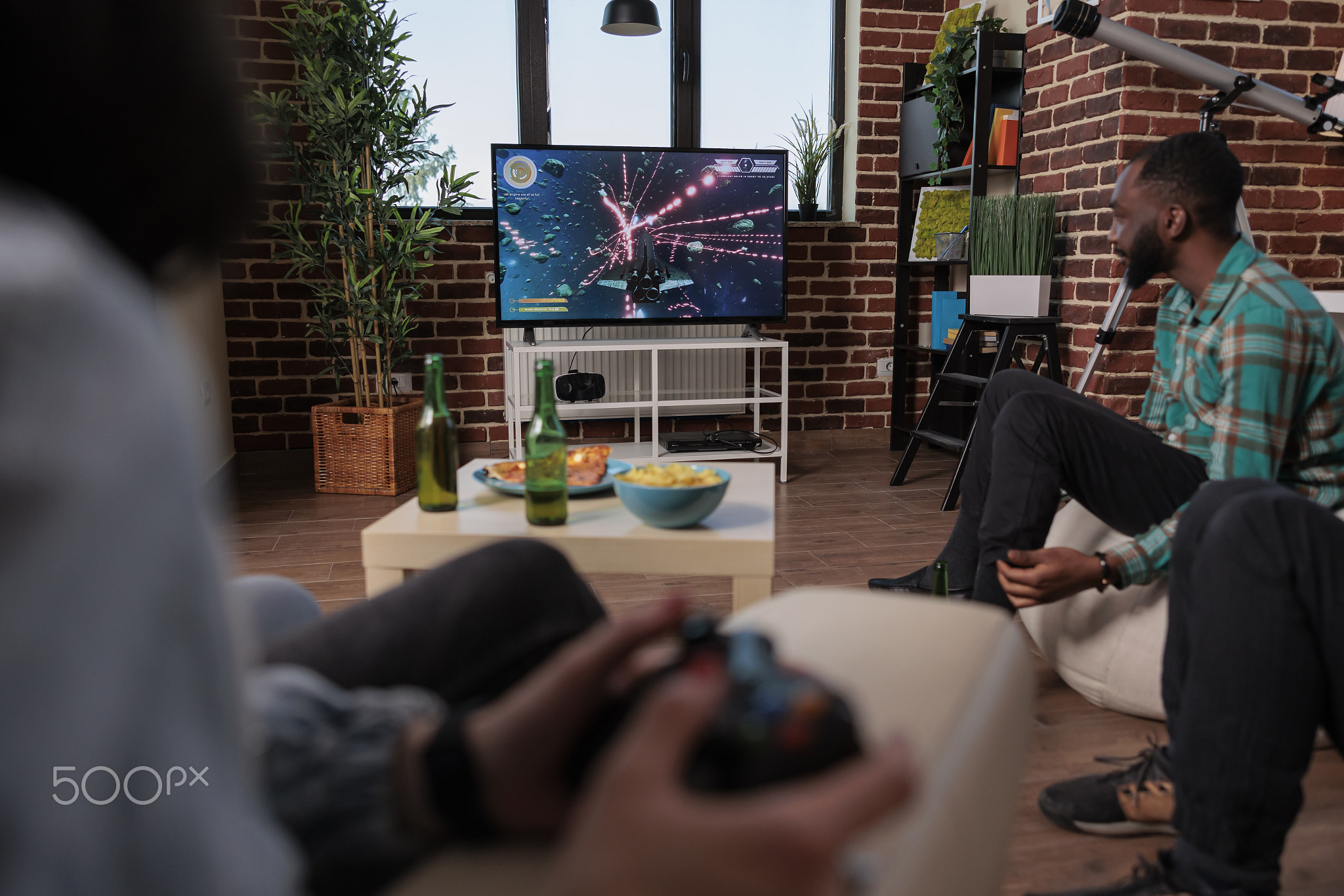 Men and women using tv console and joystick to play video games