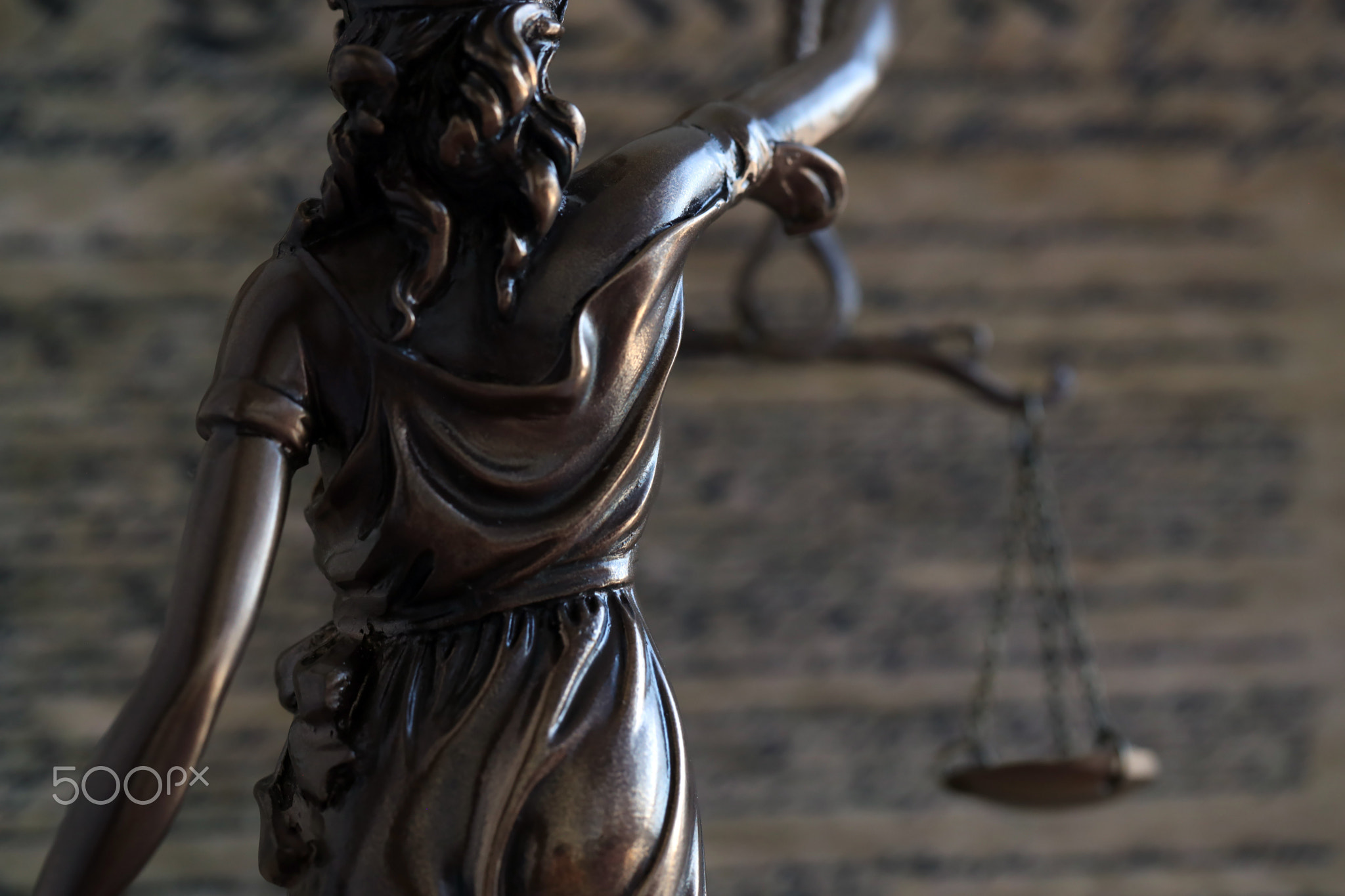 Dark scene with Lady Justice and US Constitution page. Lawsuit and judgement in USA