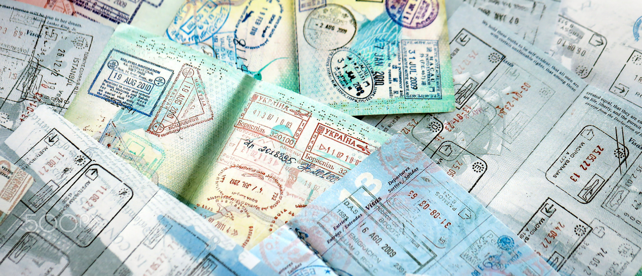 Big amount of passport pages full of colorful stamps after travel and border crossing