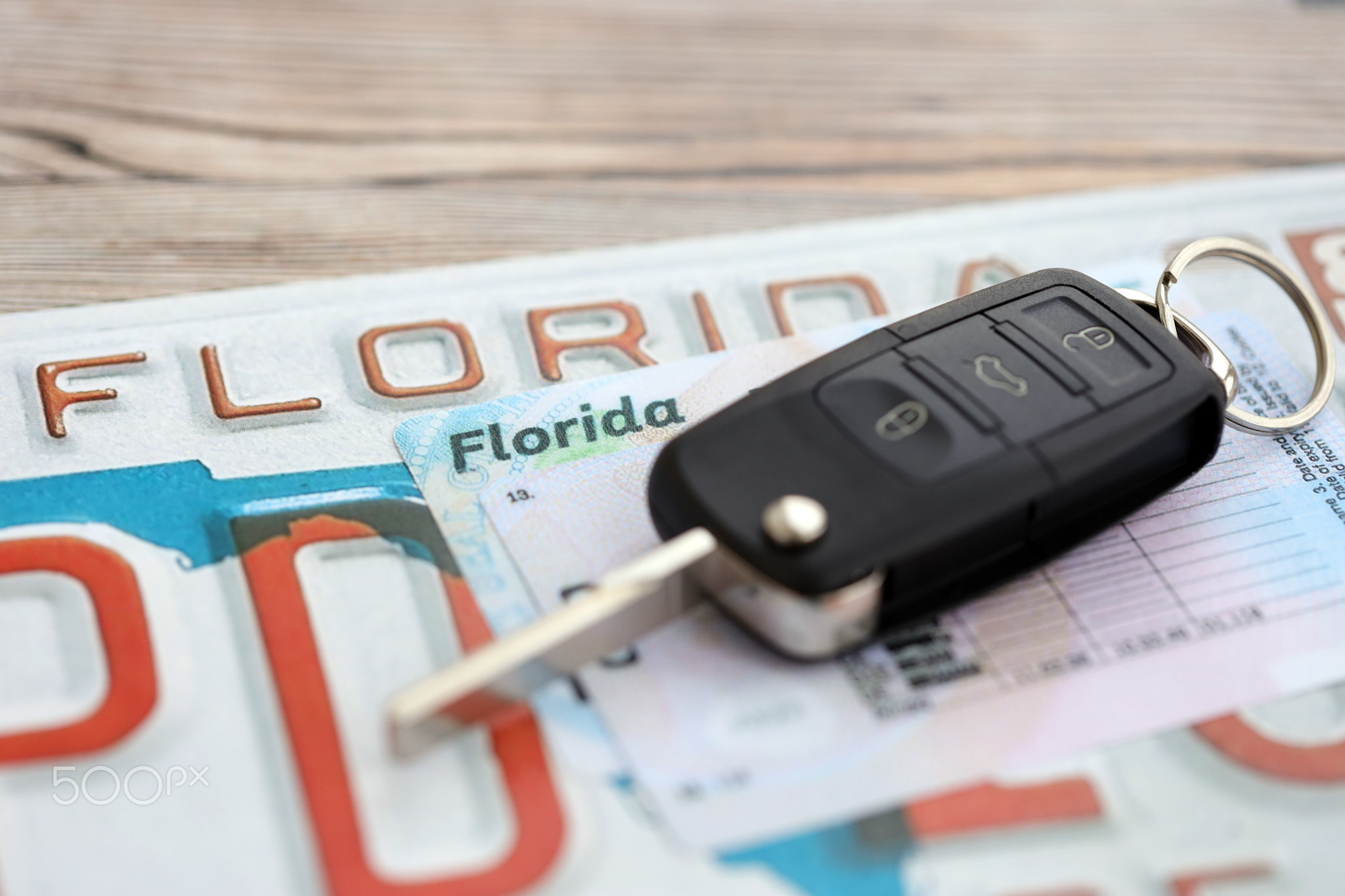Remote control car keys on Florida license plate with driver license. Car driving in Florida