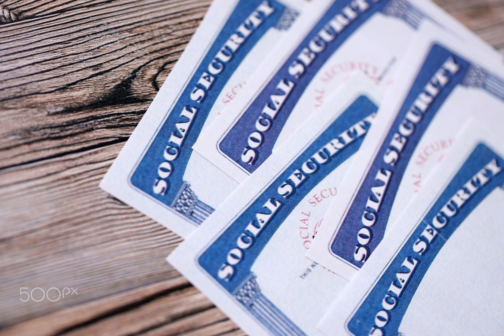 Social security number cards on brown wooden background surface