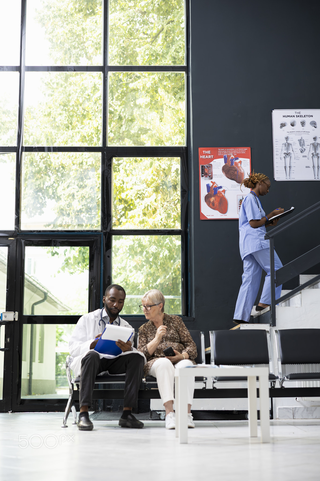 Friendly hospital staff offers medical assistance and evaluation to older woman
