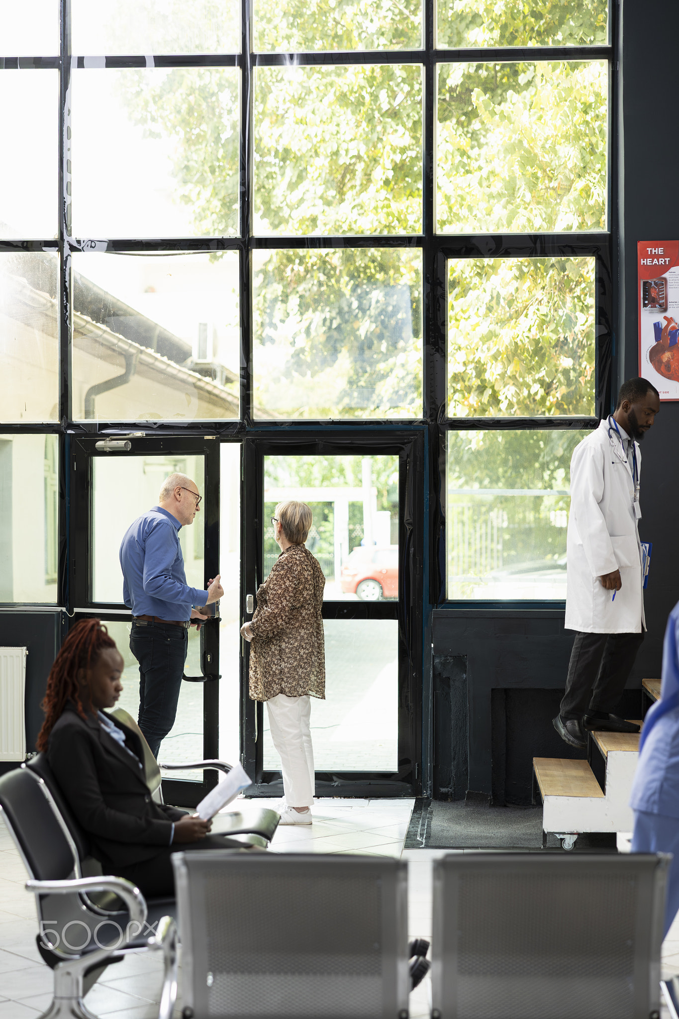 Senior people leaving the medical facility lobby after a consultation