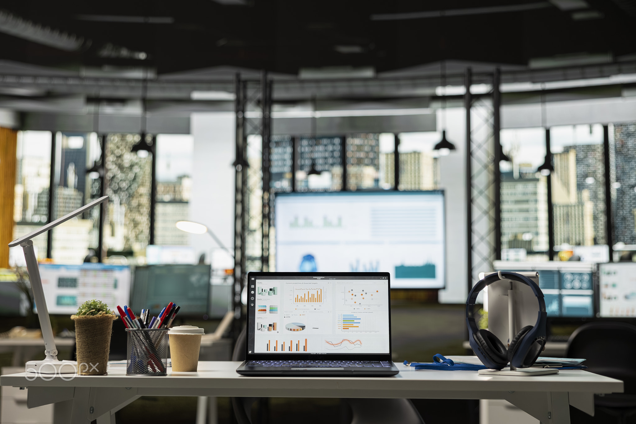 Vacant office workspace with laptop and organized desk