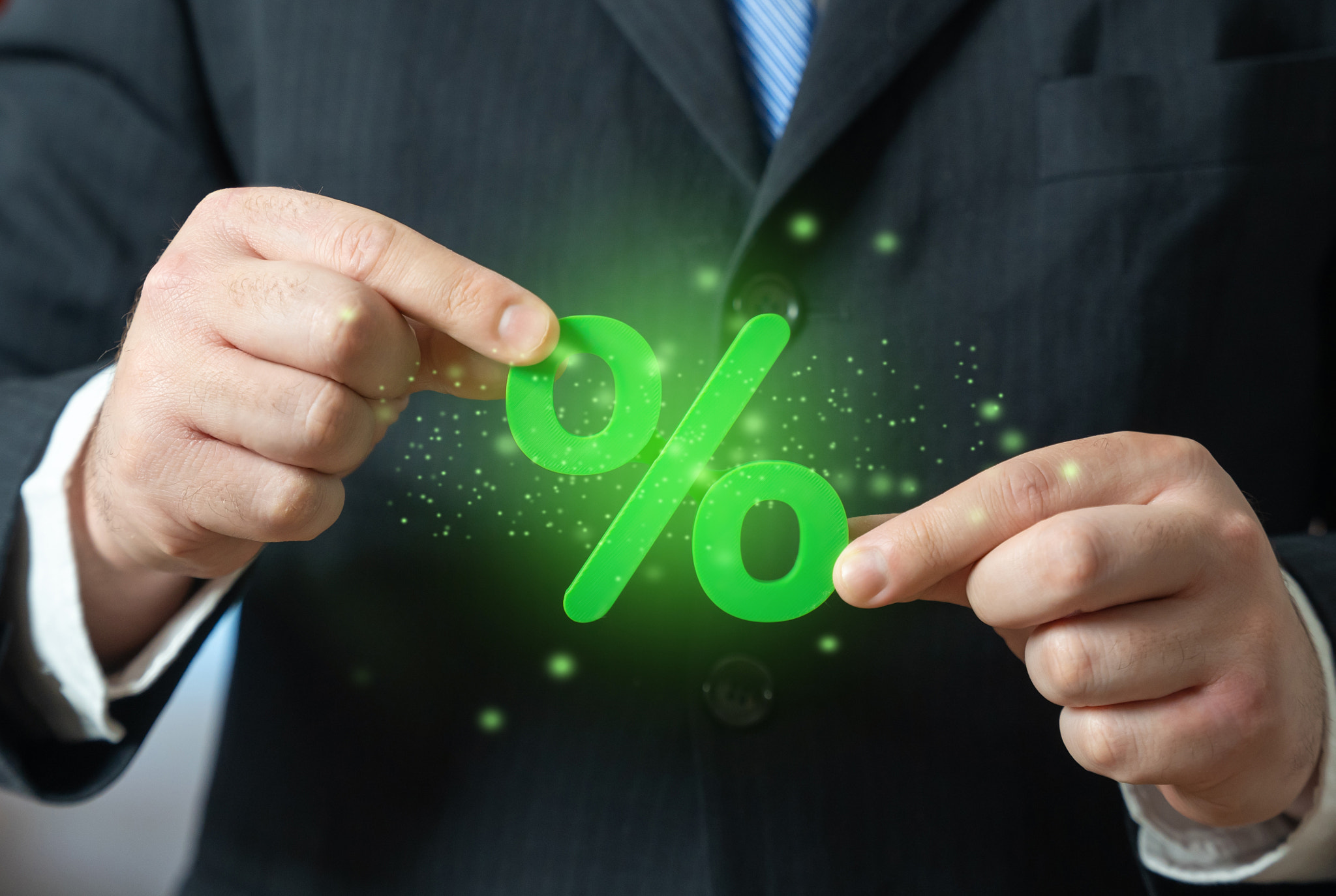 Green percentage in the businessmans hands. Financial benefits and banking opportunities. Investment