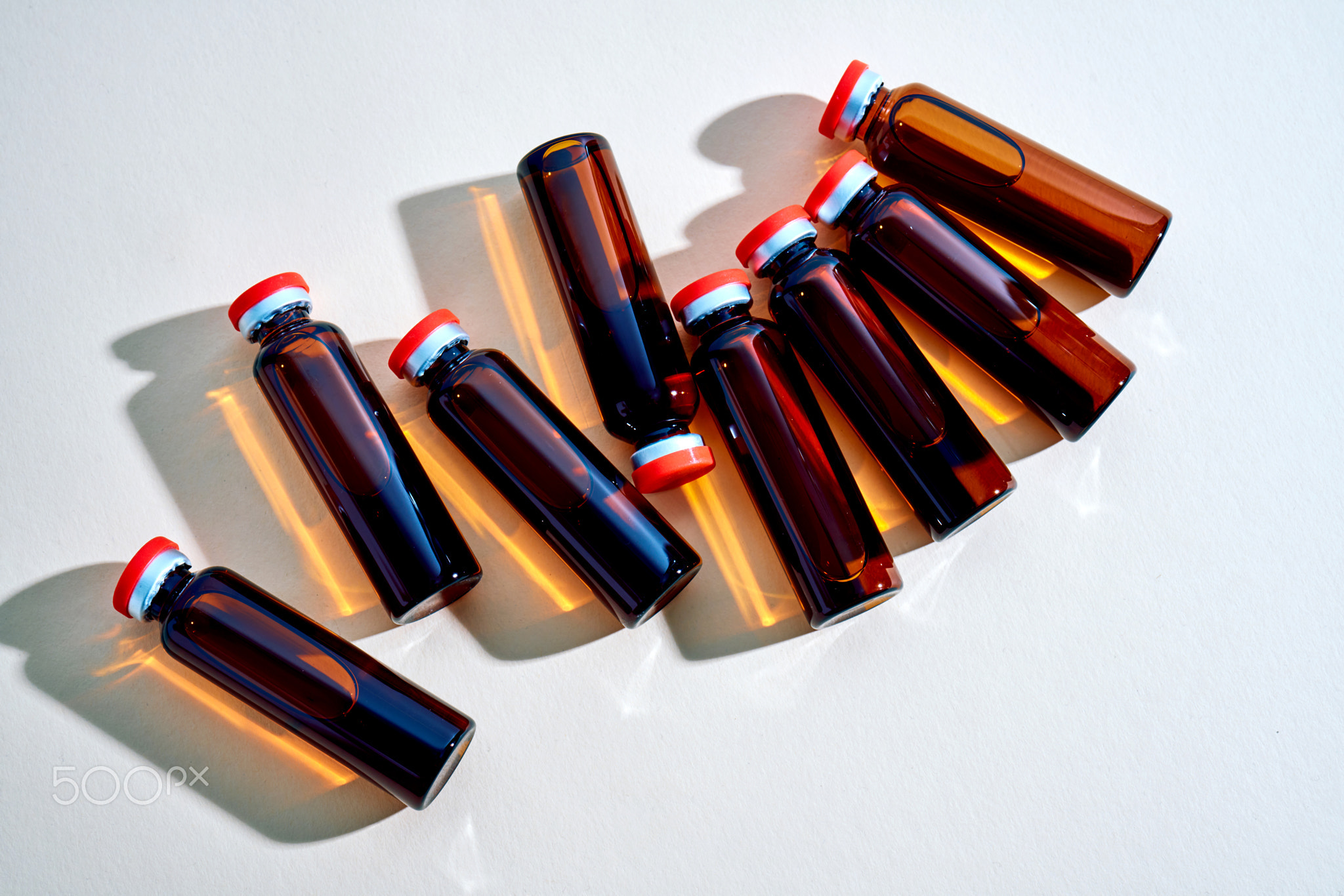 Vials containing amber liquid for medical research and treatment