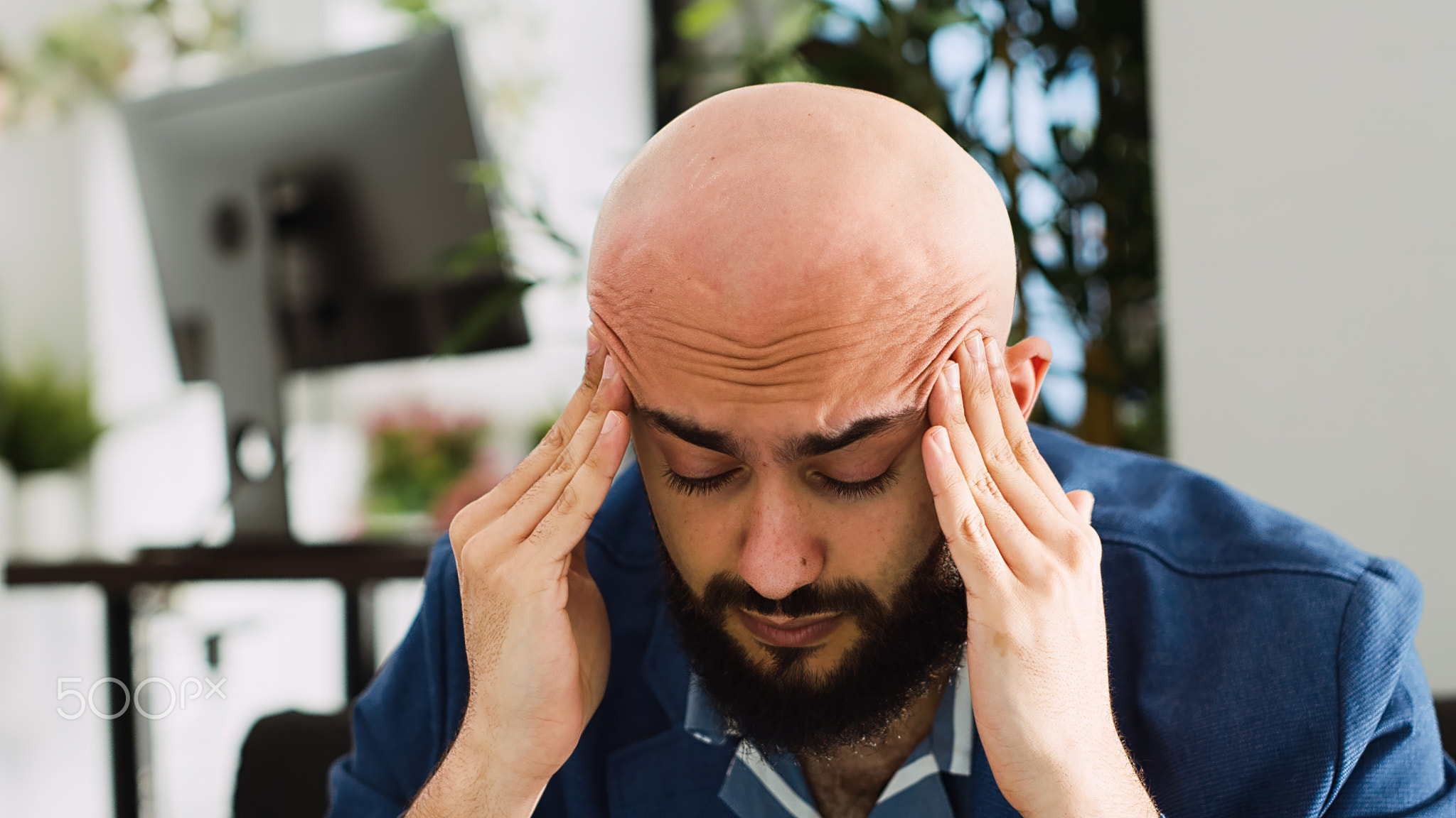 Sick businessman suffering from migraine
