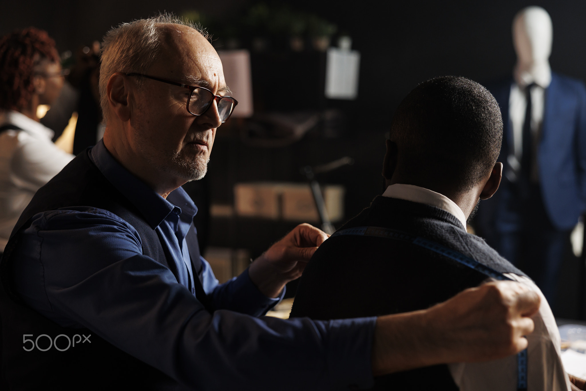 skilled suitmaker measuring elegant suit