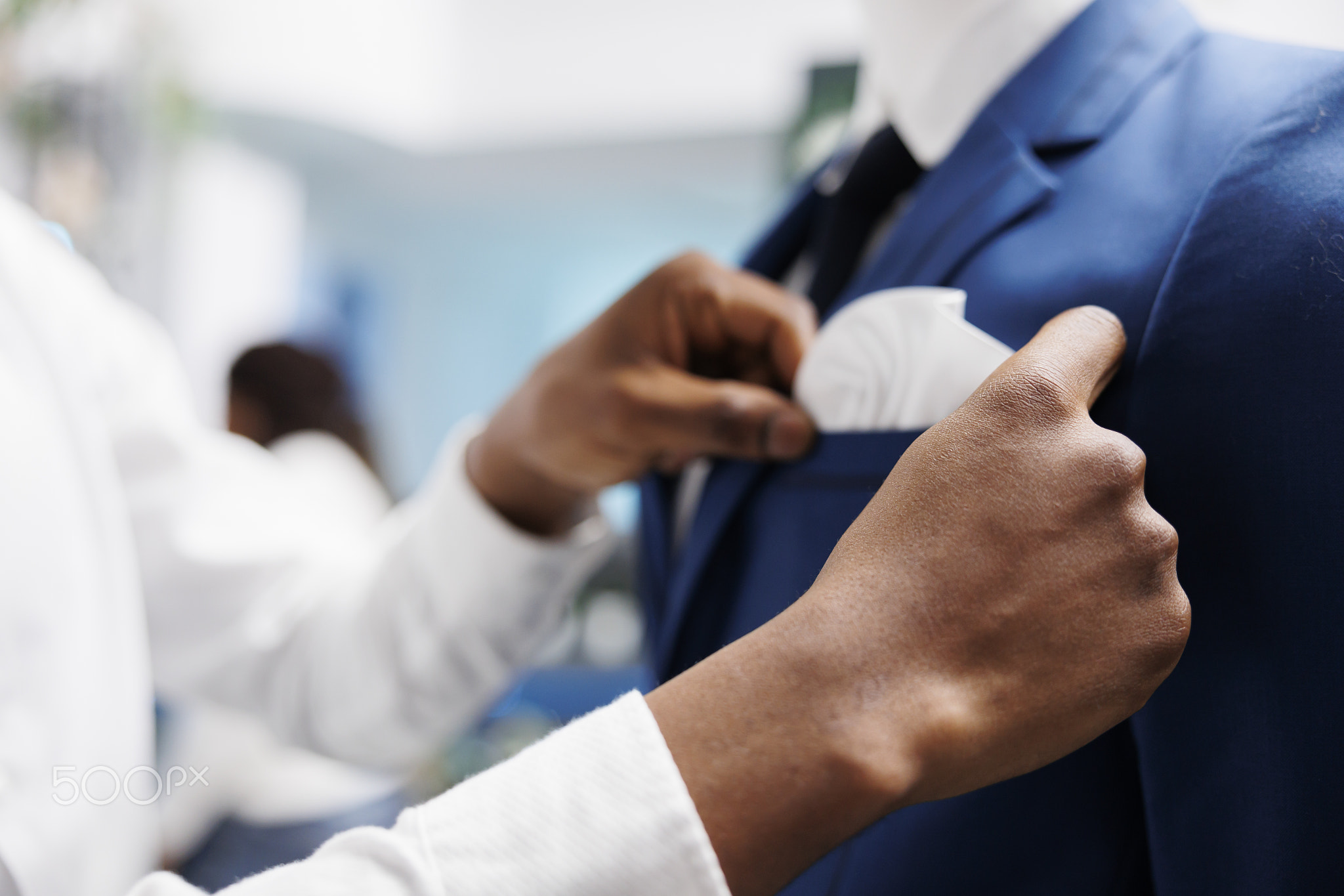 Man hands checking jacket fit on mannequin in store