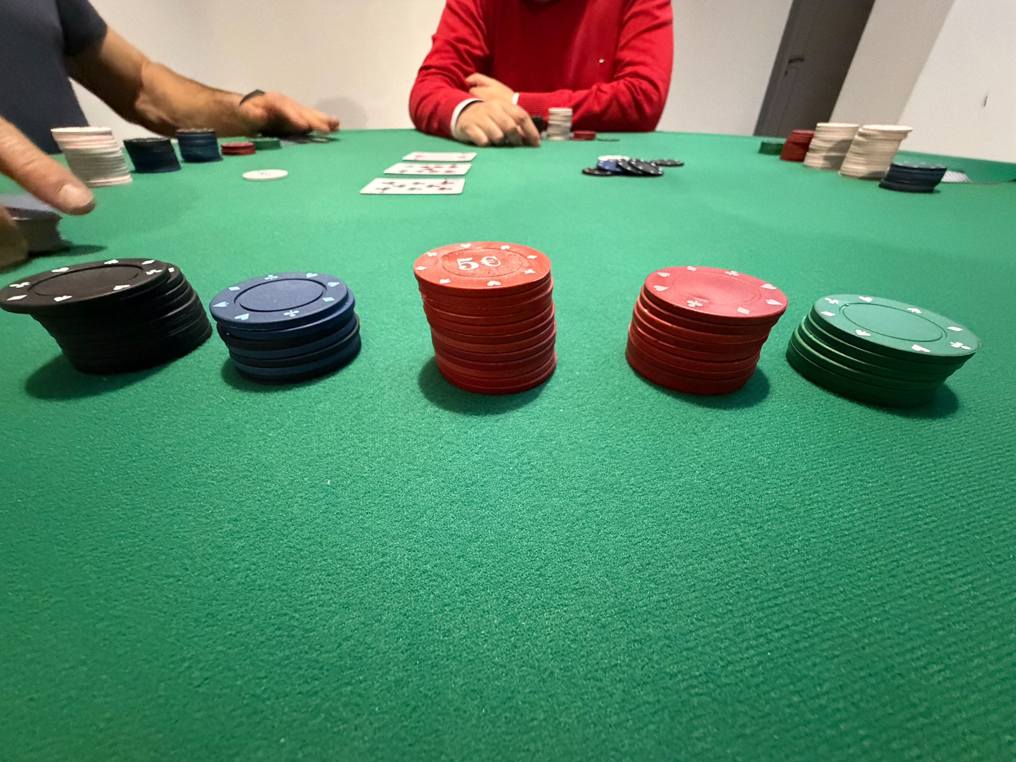 Poker game at the green table with chips and cards