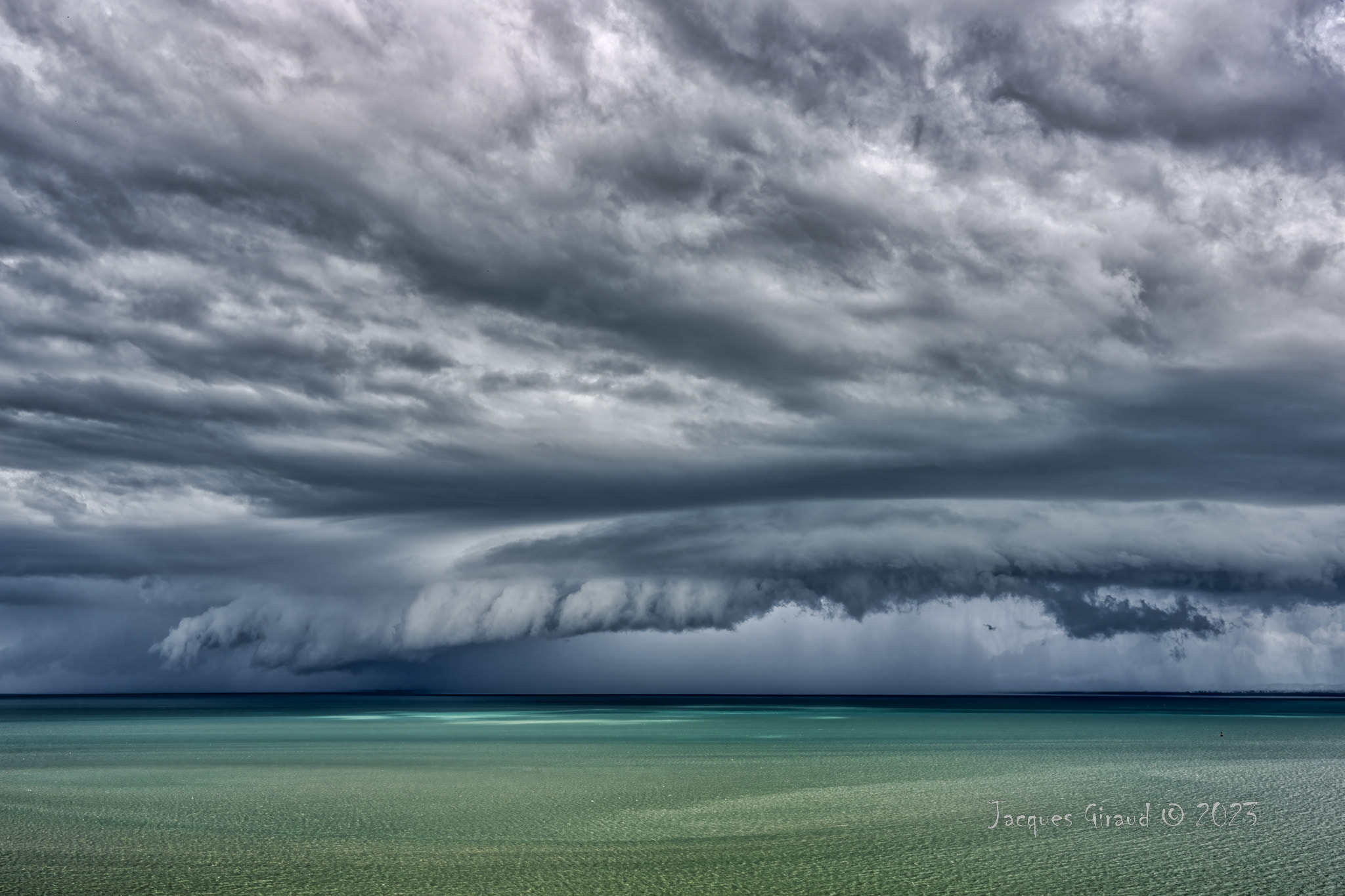 Storm Clouds Gather Over Water Portraying Imminent Change | nature