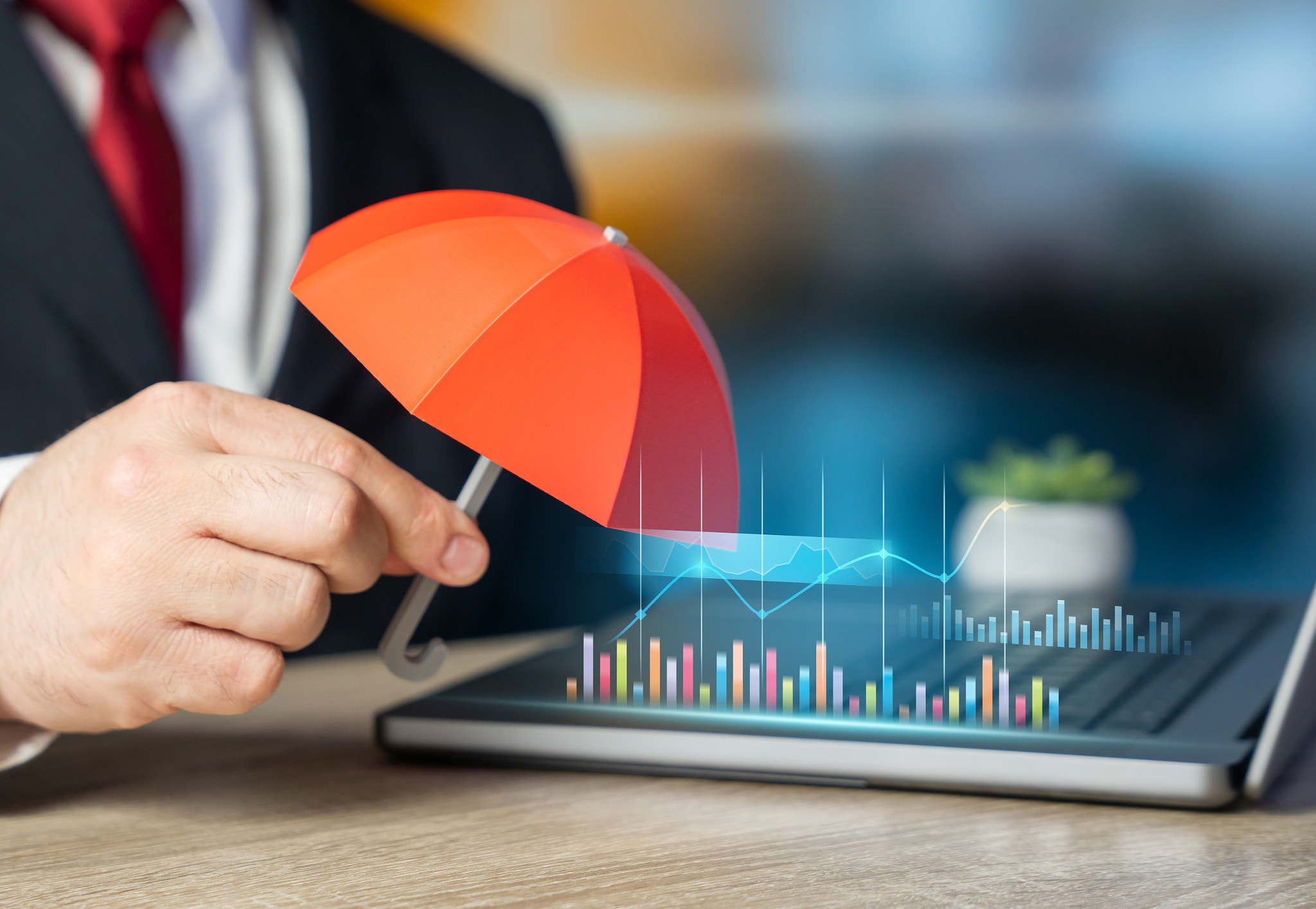 Businessman with an umbrella. Concept of insurance and protection for business, property, and health