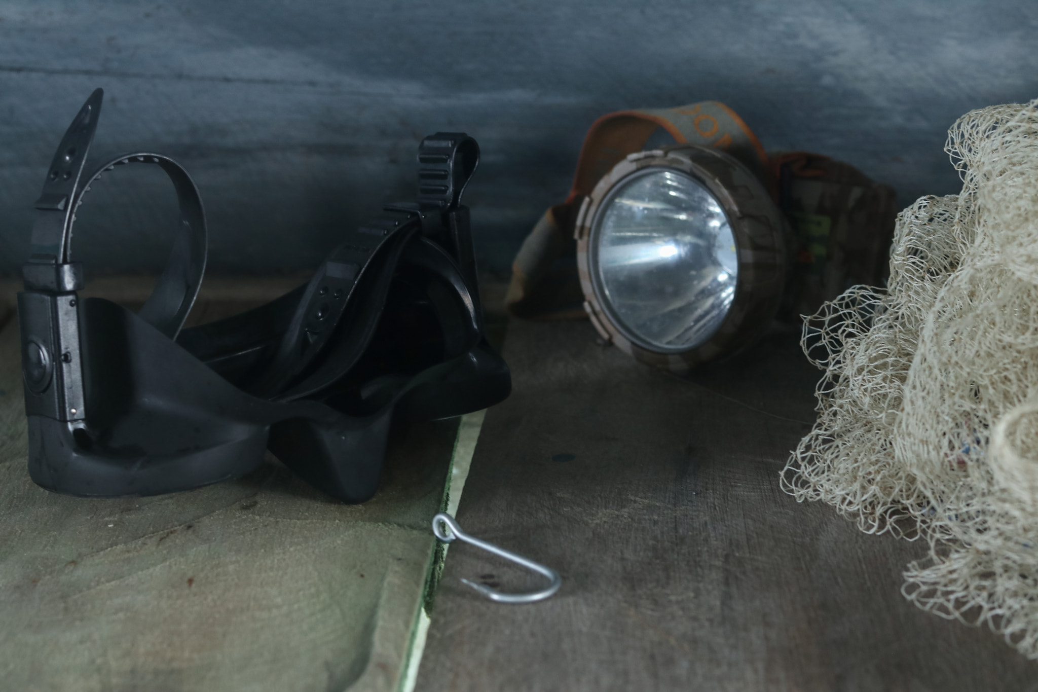Night Fishing Equipment and Diving Gear on Rustic Wooden Background