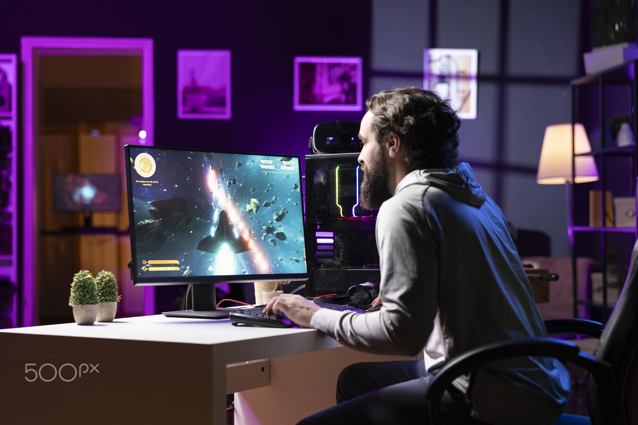 Gamer using crosshair overlay to hit targets in science fiction arcade game