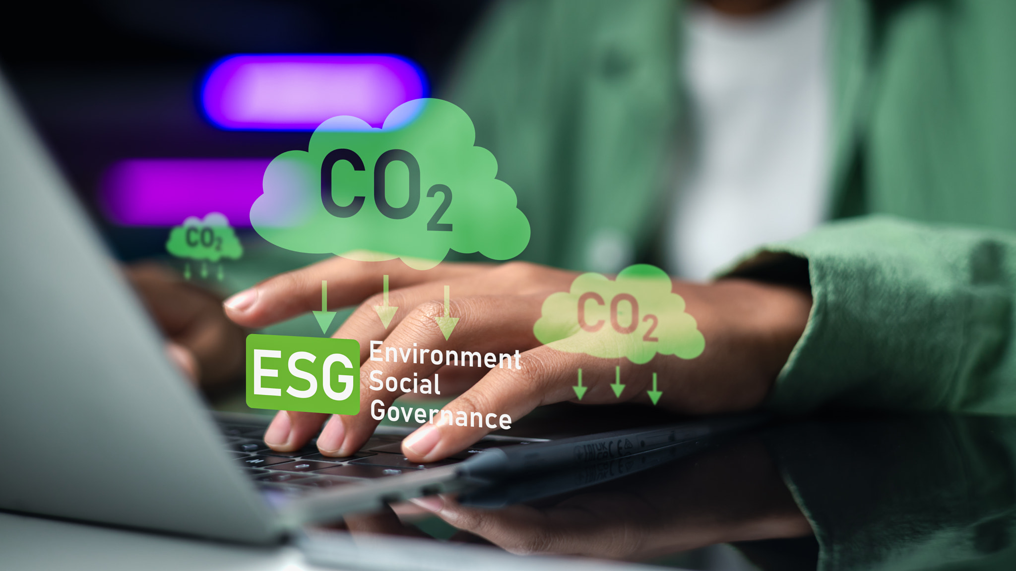 Professional woman typing on a laptop with digital ESG and CO2 reduction cloud graphics. Business en