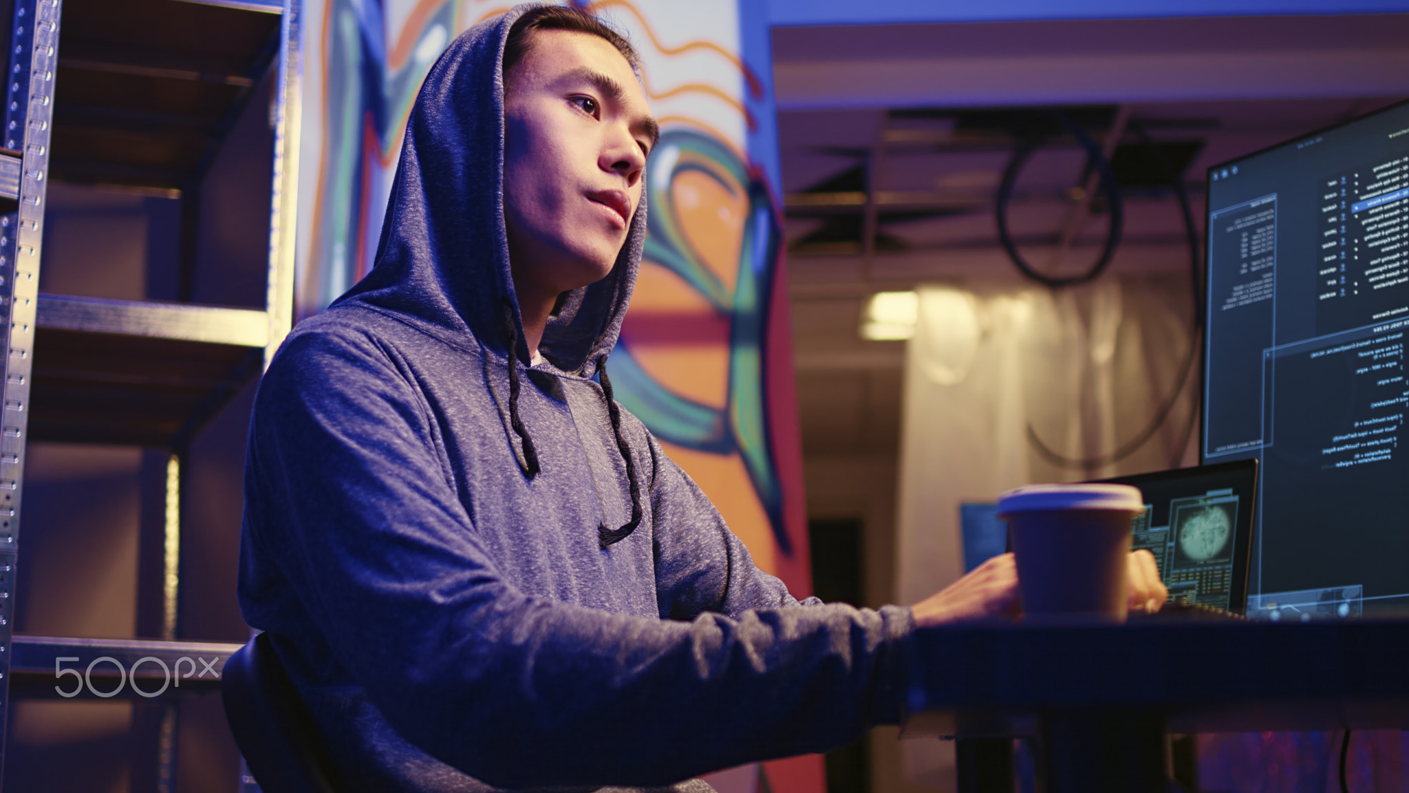 Asian hacker in underground base getting past anti tamper measures implemented by companies trying