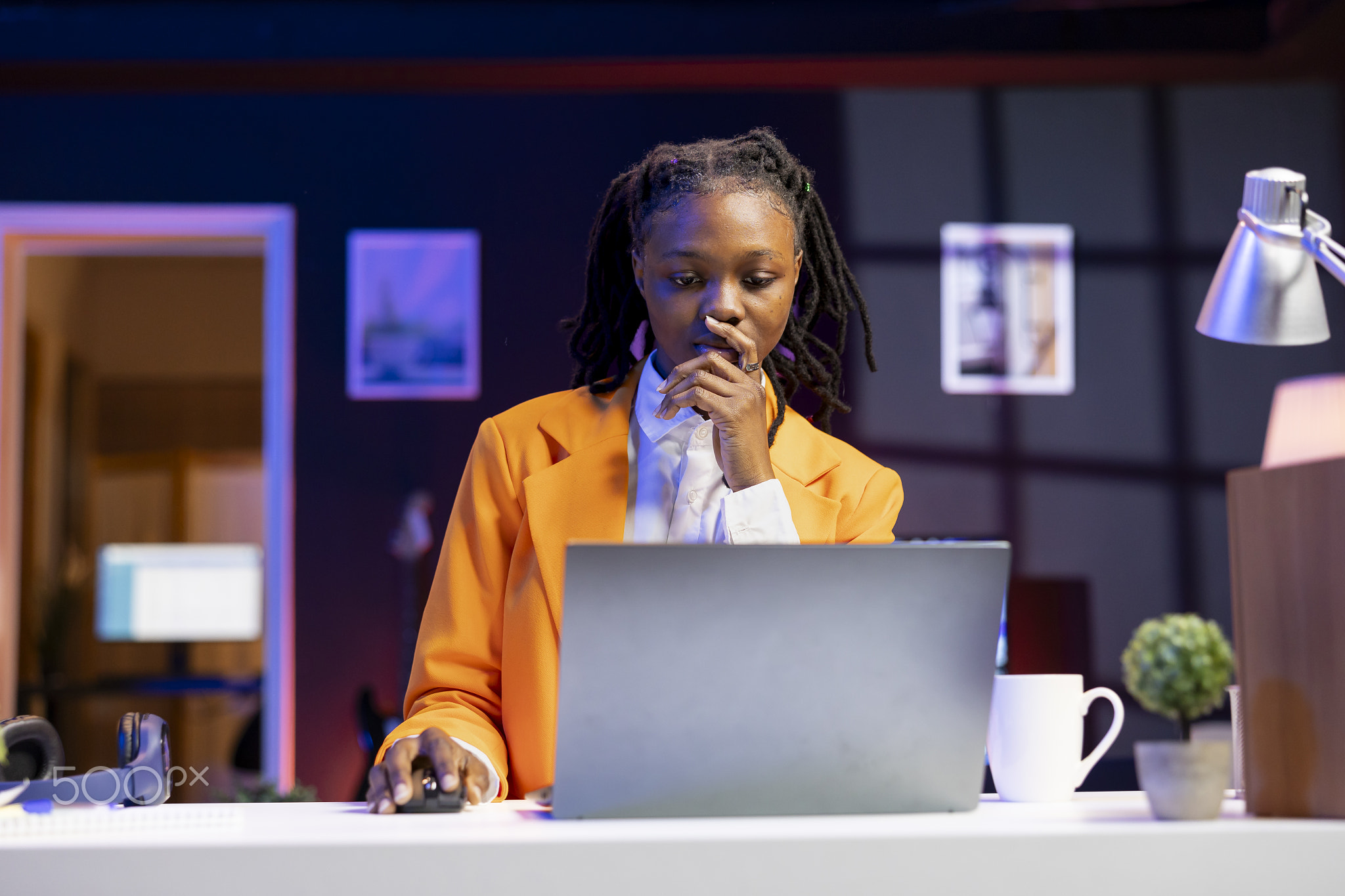 Hardworking teenager studying at home, browsing internet on notebook