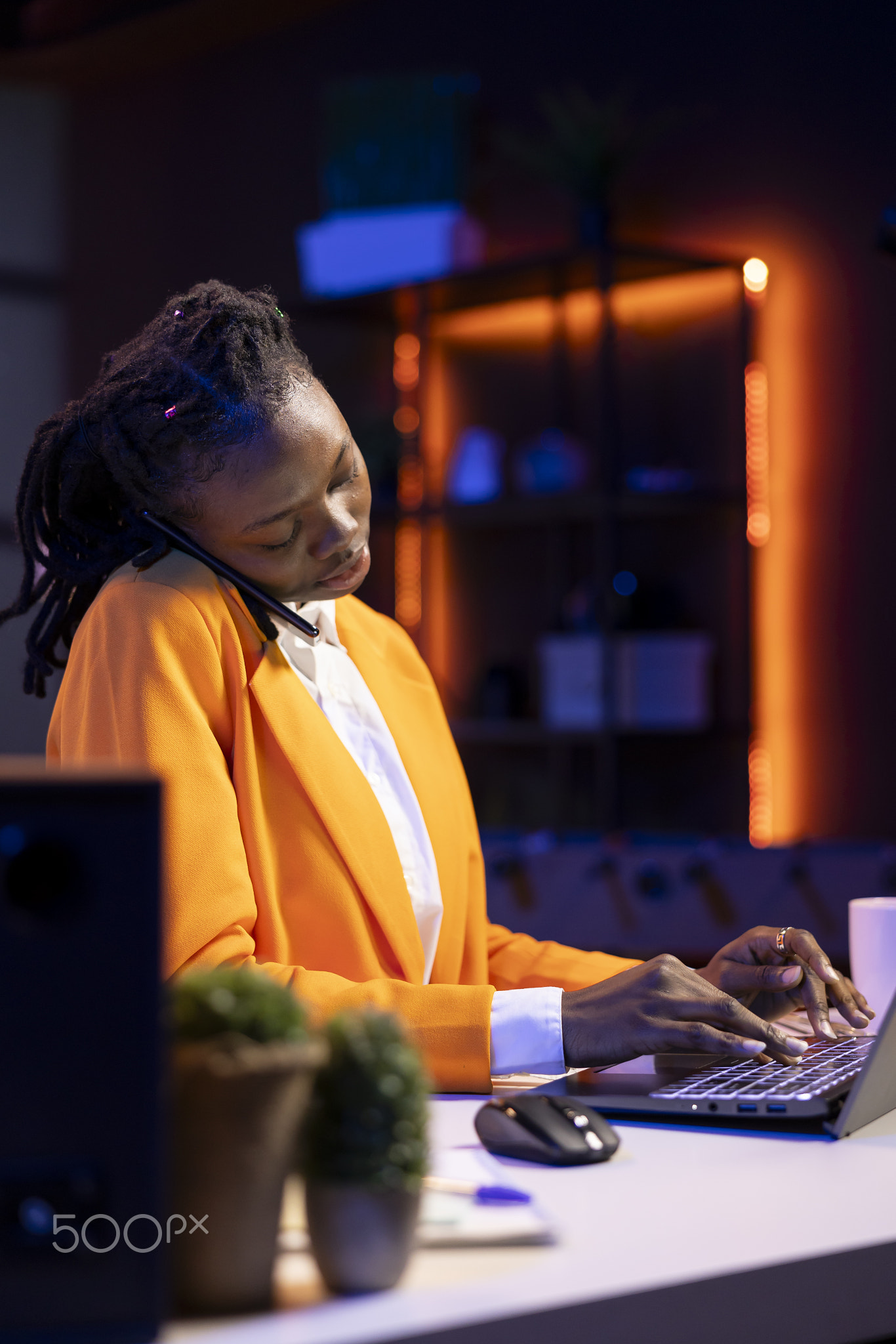 Student at desk talking with school colleague in phone call