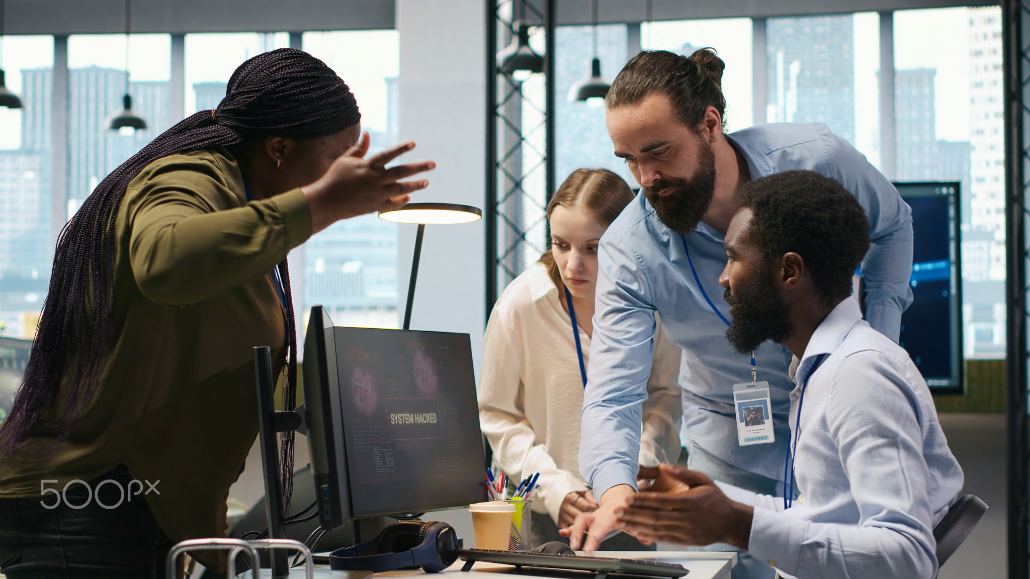 Programmer in office requesting help from coworkers to fix critical error