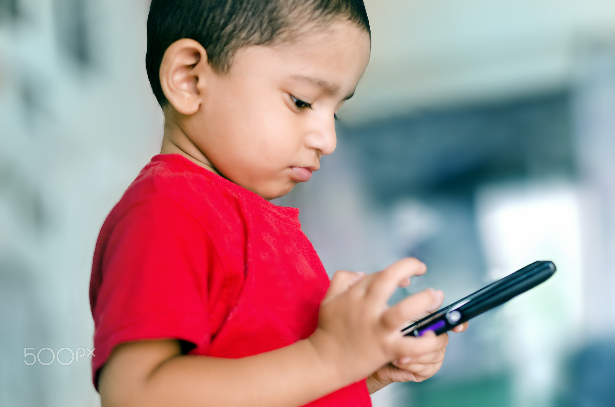 child playing with mobile phone